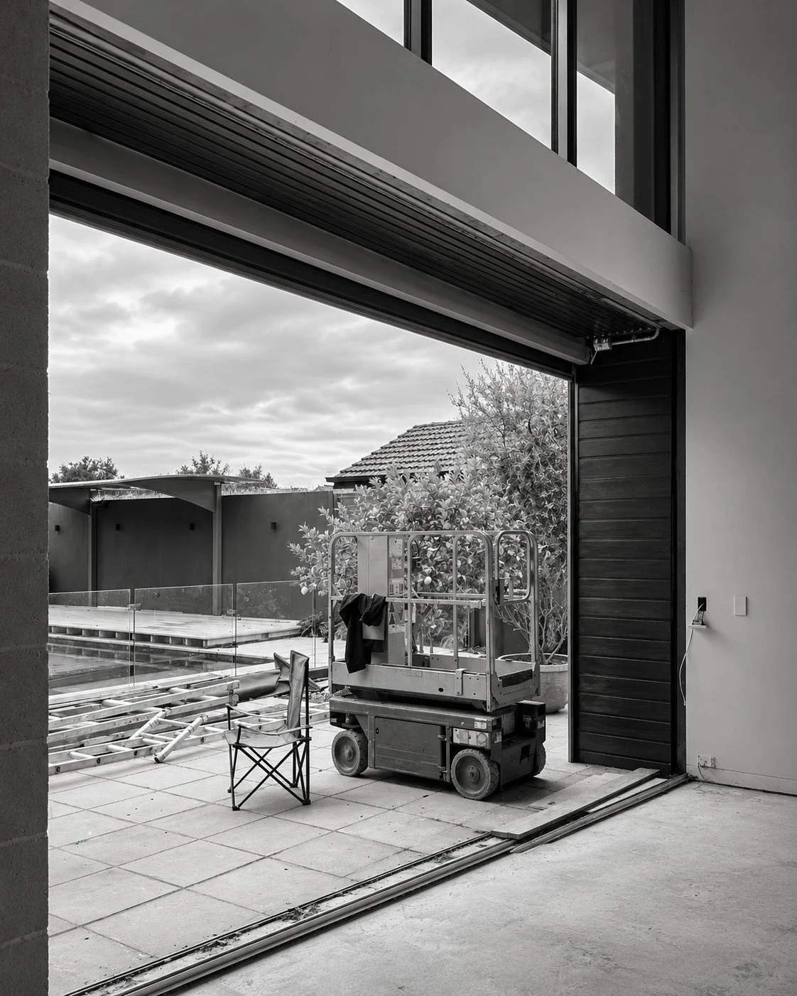 Lorde House high-level glazing detail with views of established trees.