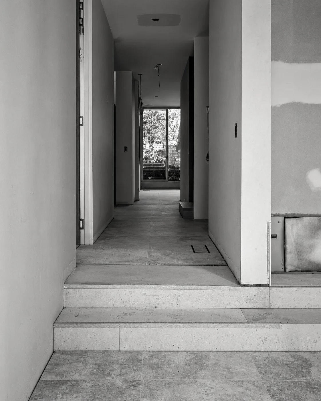 Lorde House internal hallway under construction, framed by tall doorways.