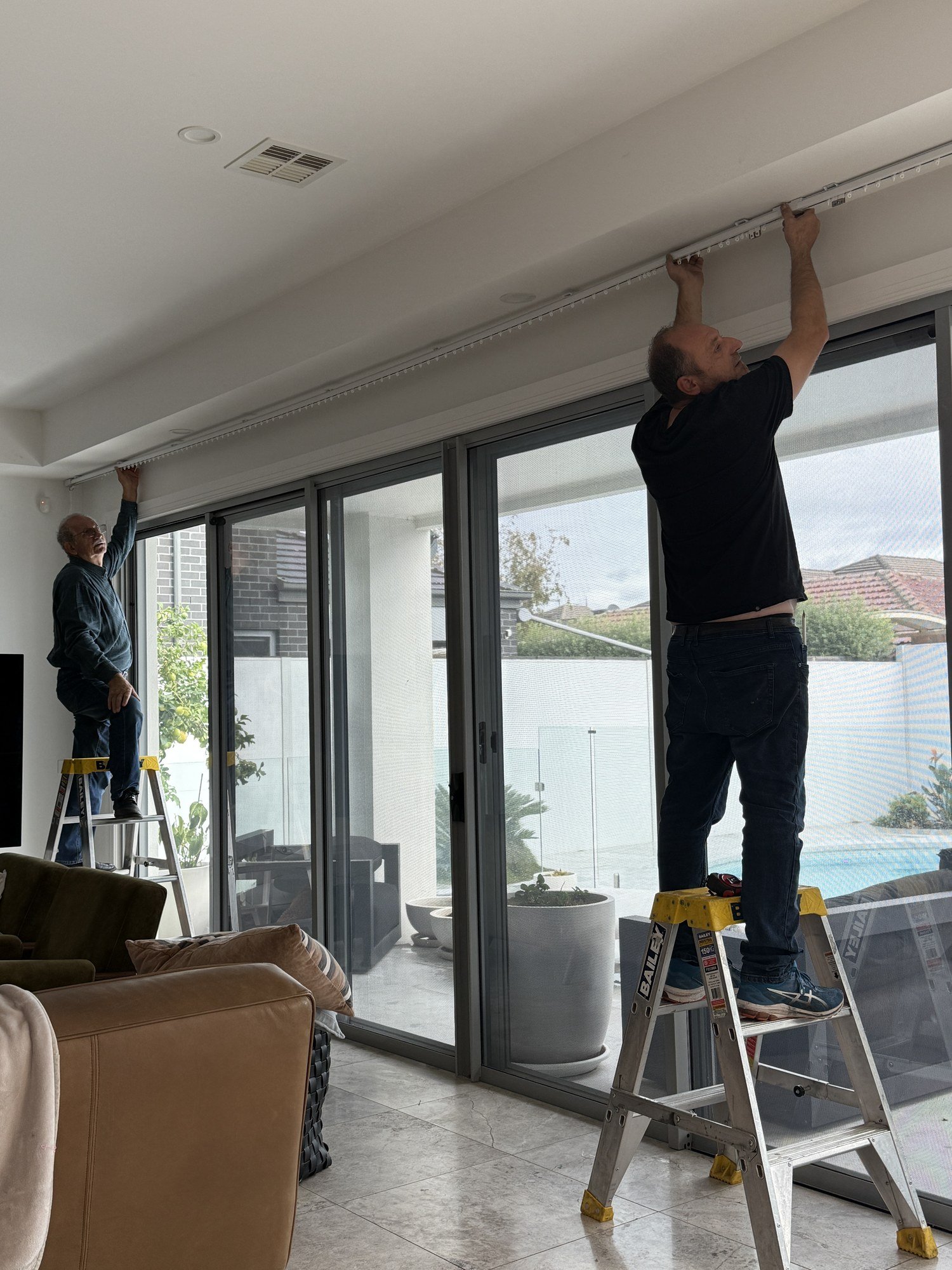 Custom curtains being installed on site.