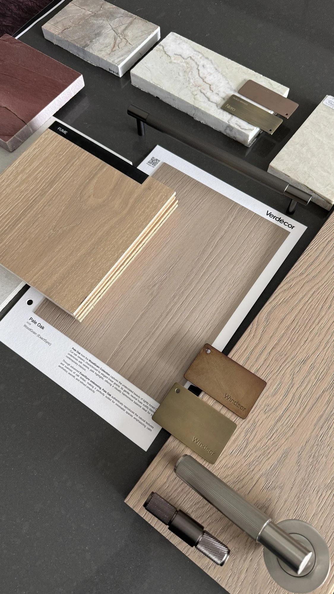 Natural stone, textile and timber samples arranged during an interior material study.