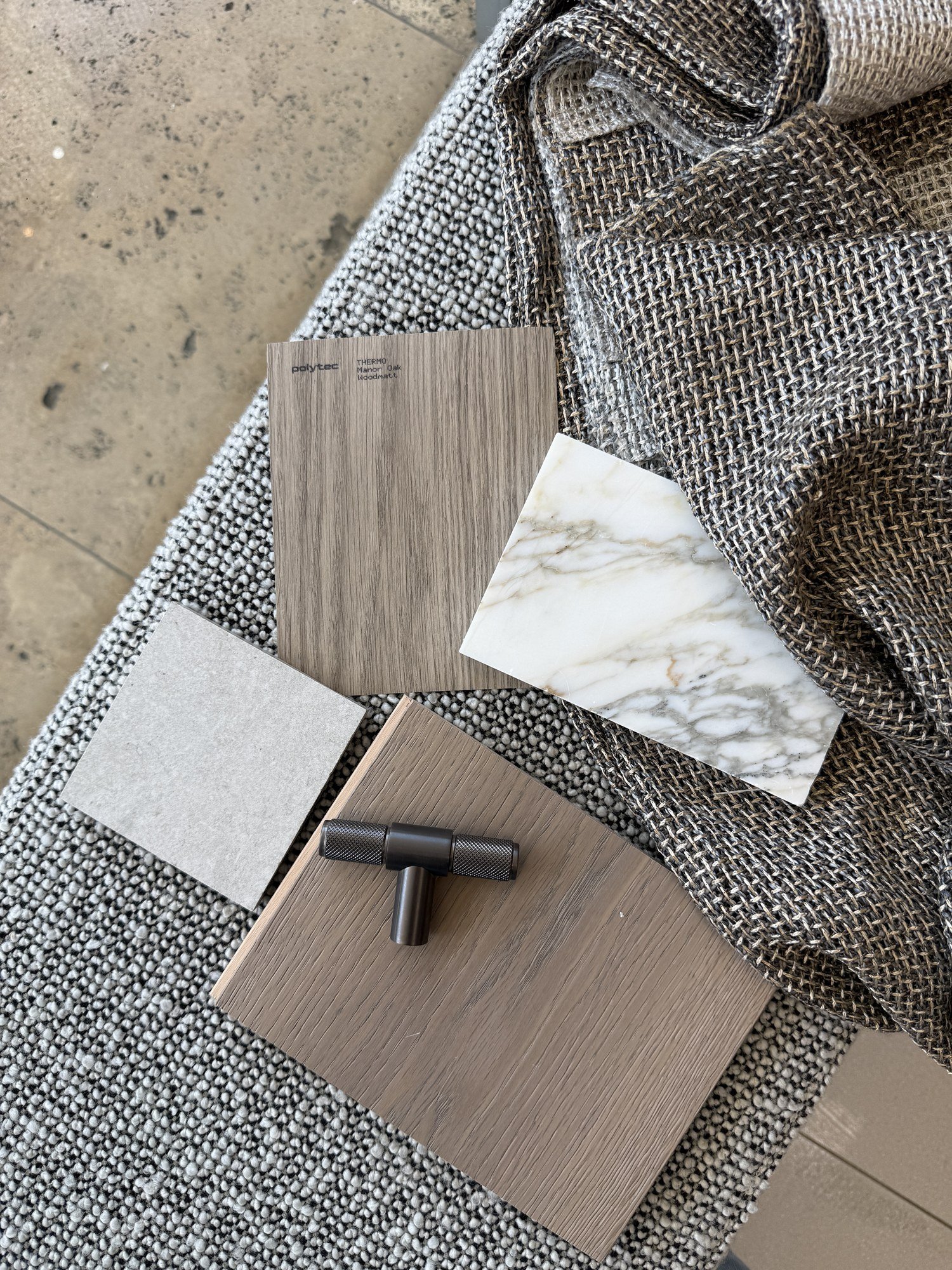 A considered palette of stone, timber, fabric and decorative finishes.