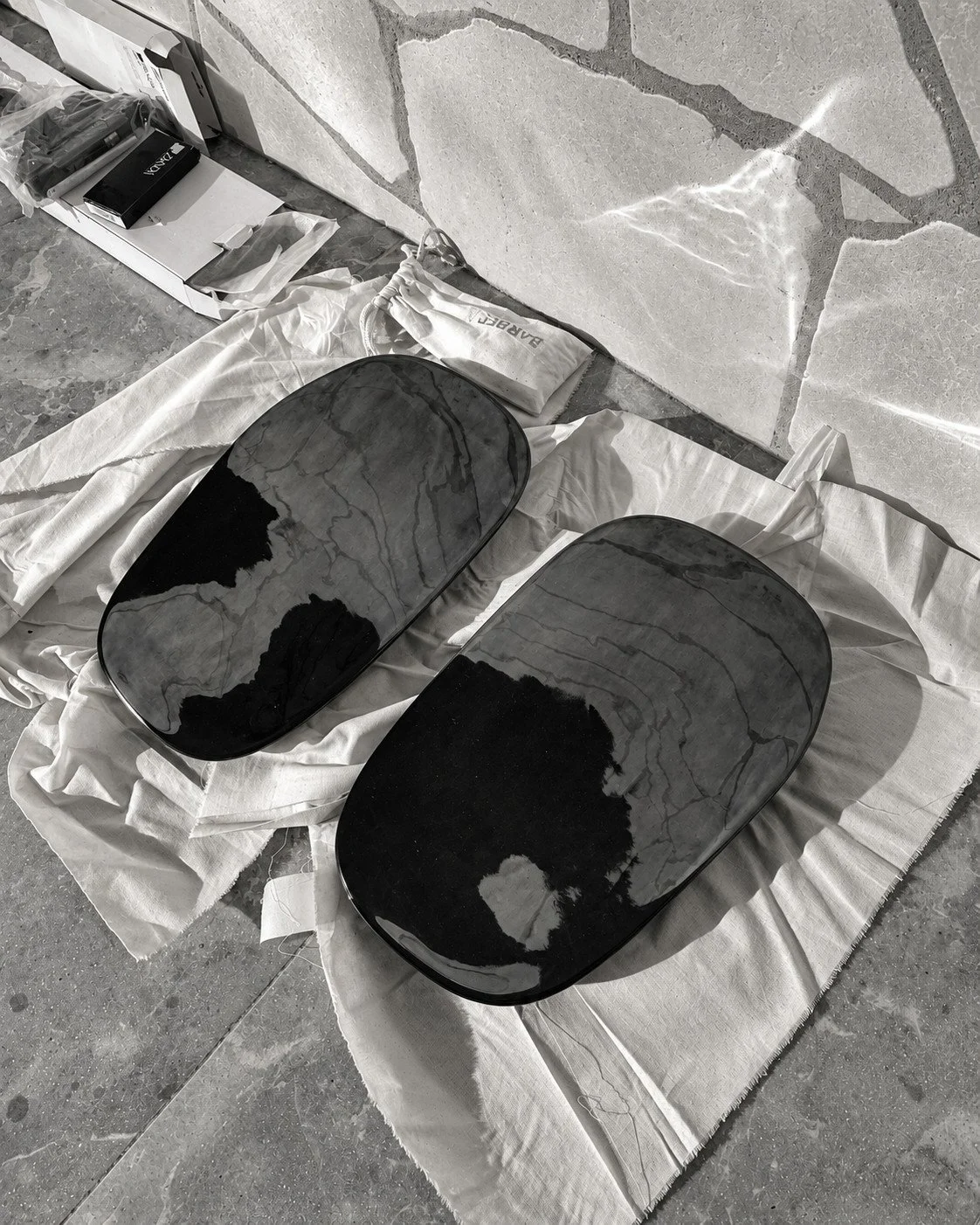 Two dark stone basins viewed from above during the Alpine House material selection process.