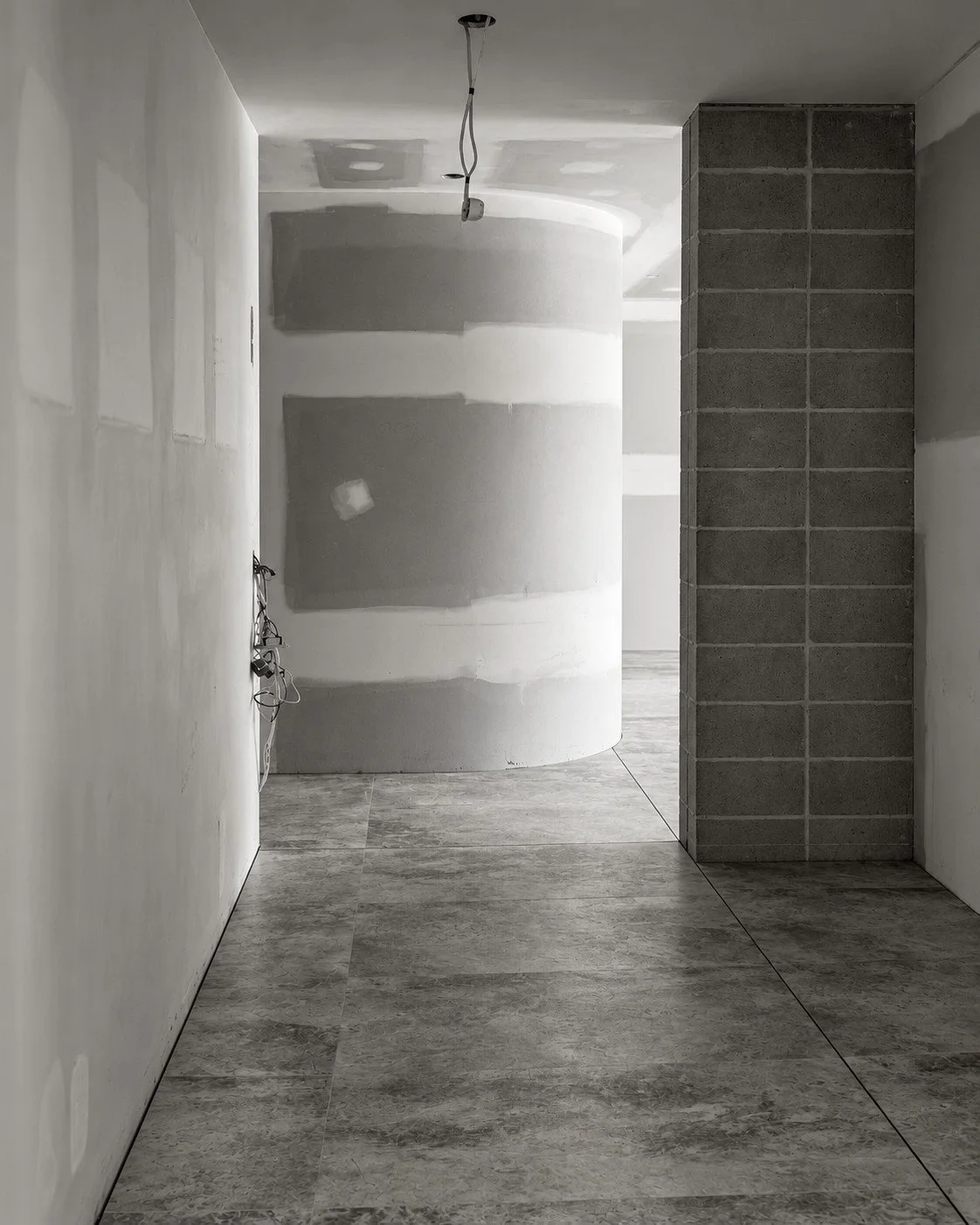 Lorde House hallway under construction with tall door openings and unfinished plasterboard walls.