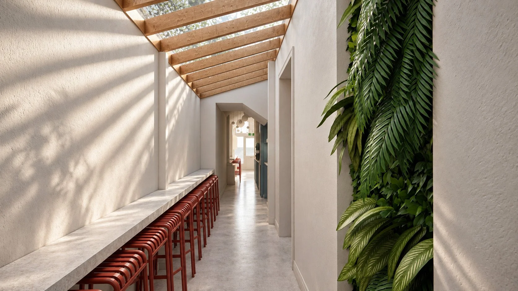 a living green wall brings texture to the glazed dining passage, alongside red stools, pale counters and polished concrete flooring.