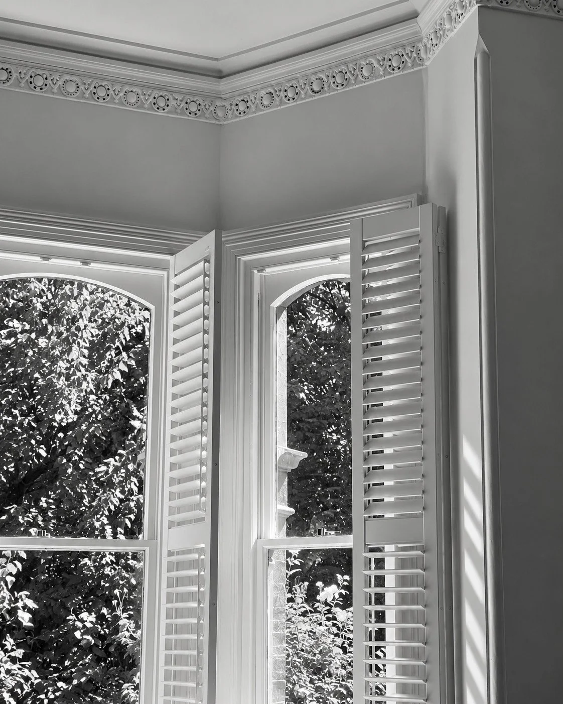 Craigneal heritage bay window with shutters and ornate ceiling trim.