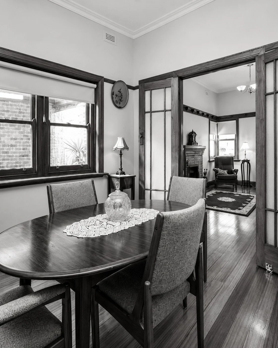 Botanica original dining room with timber-framed glazed doors opening to the adjoining living room.