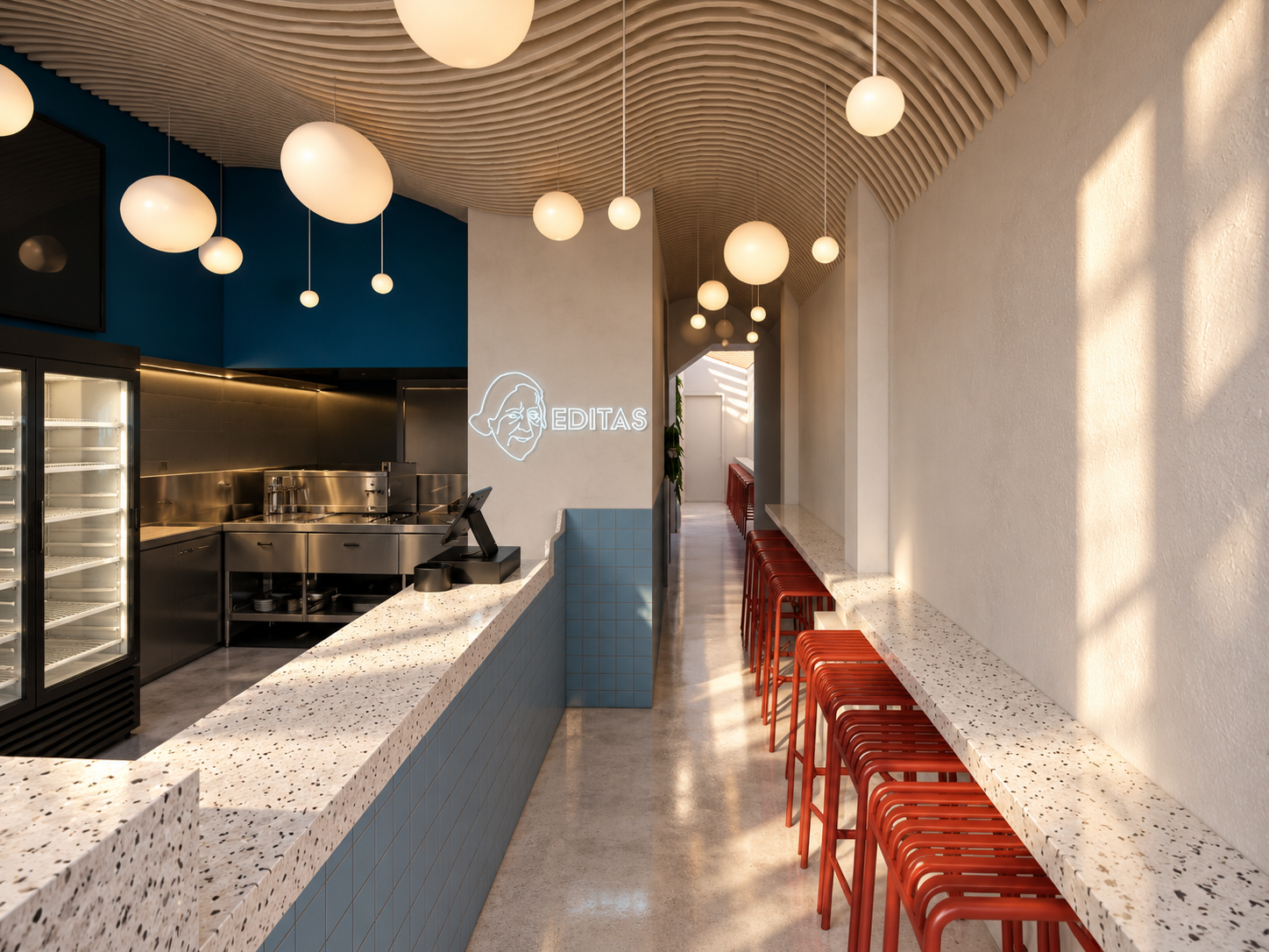 a long counter and repeated red stools create rhythm through the narrow space while keeping the layout open and functional.