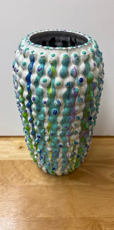 Harriet Pollack, acrylic paint in cool colors. I have been called THE WIZARD OF VASE because I transform existing vases into unique "one of a kind" creations.  I select vases that have unusual shapes or textures and add my own colors and surface enha