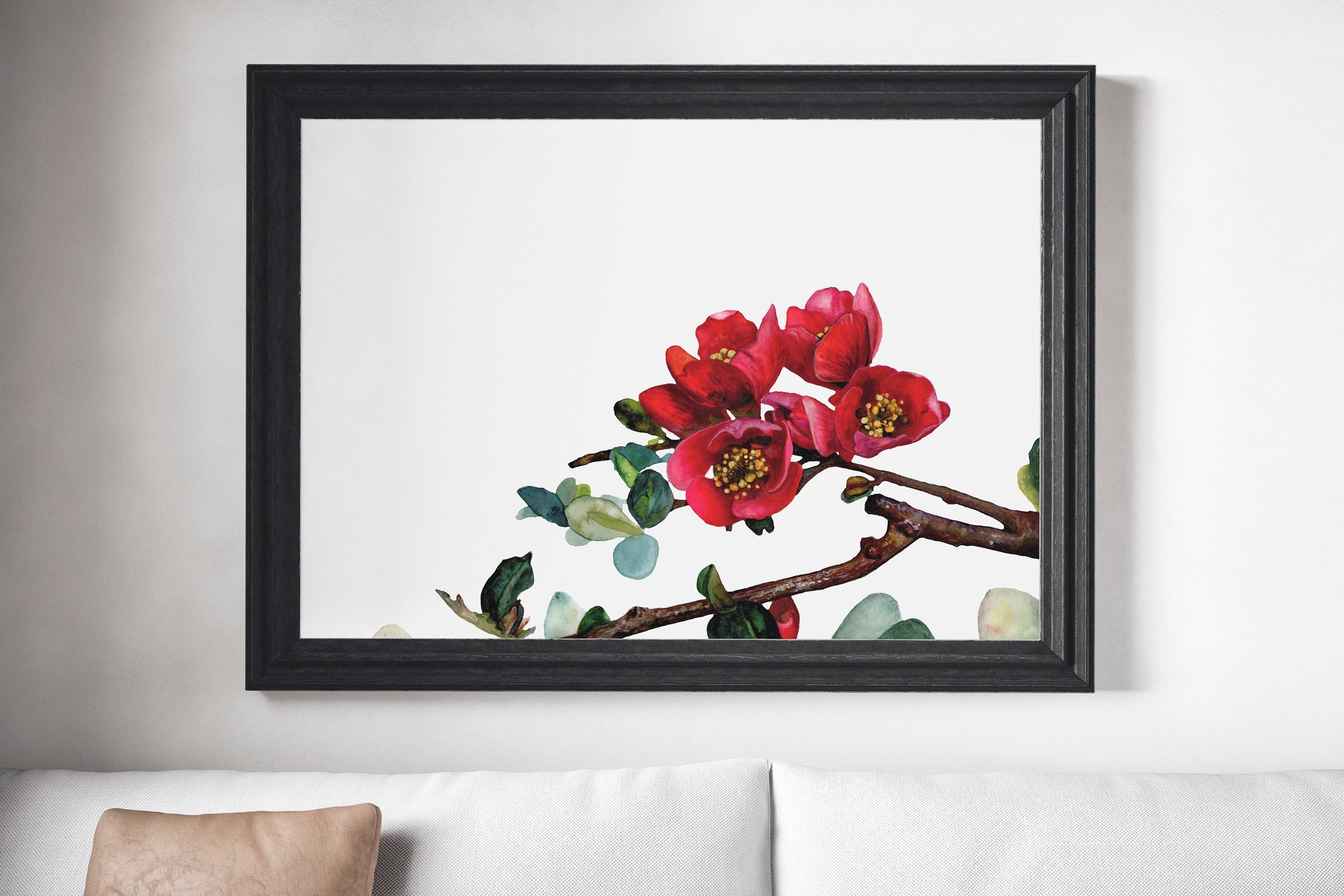 large framed watercolor print of red flowers above a sofa