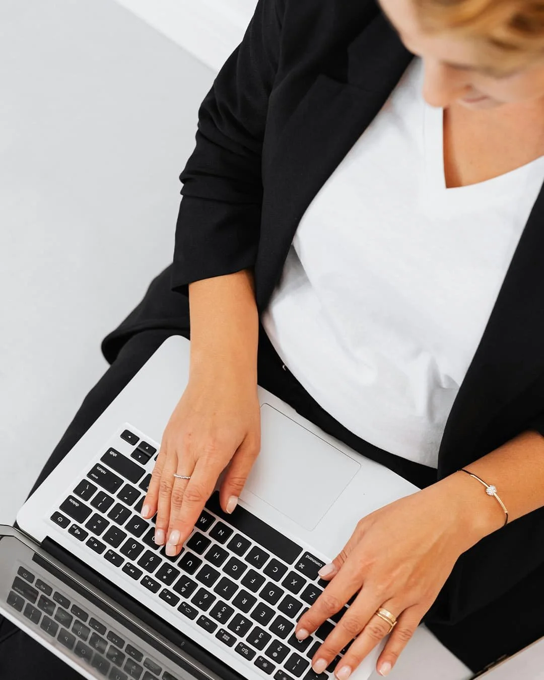 Close-up of an emerging founder focused on digital strategy and business development, set against a clean, minimalist workspace symbolizing the foundational launch phase.