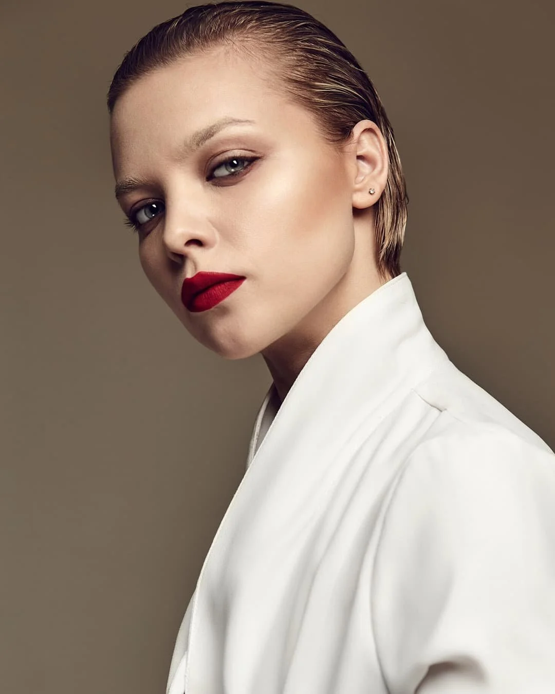 A striking, editorial-style architectural portrait featuring bold design elements and a visionary leader, symbolizing a legacy brand and market authority.