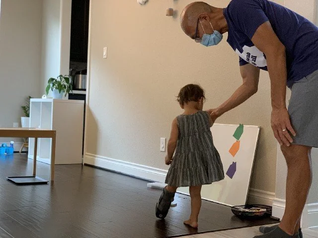 Toddler with temporary mobility, trying to walk in a early childhood classroom  setting