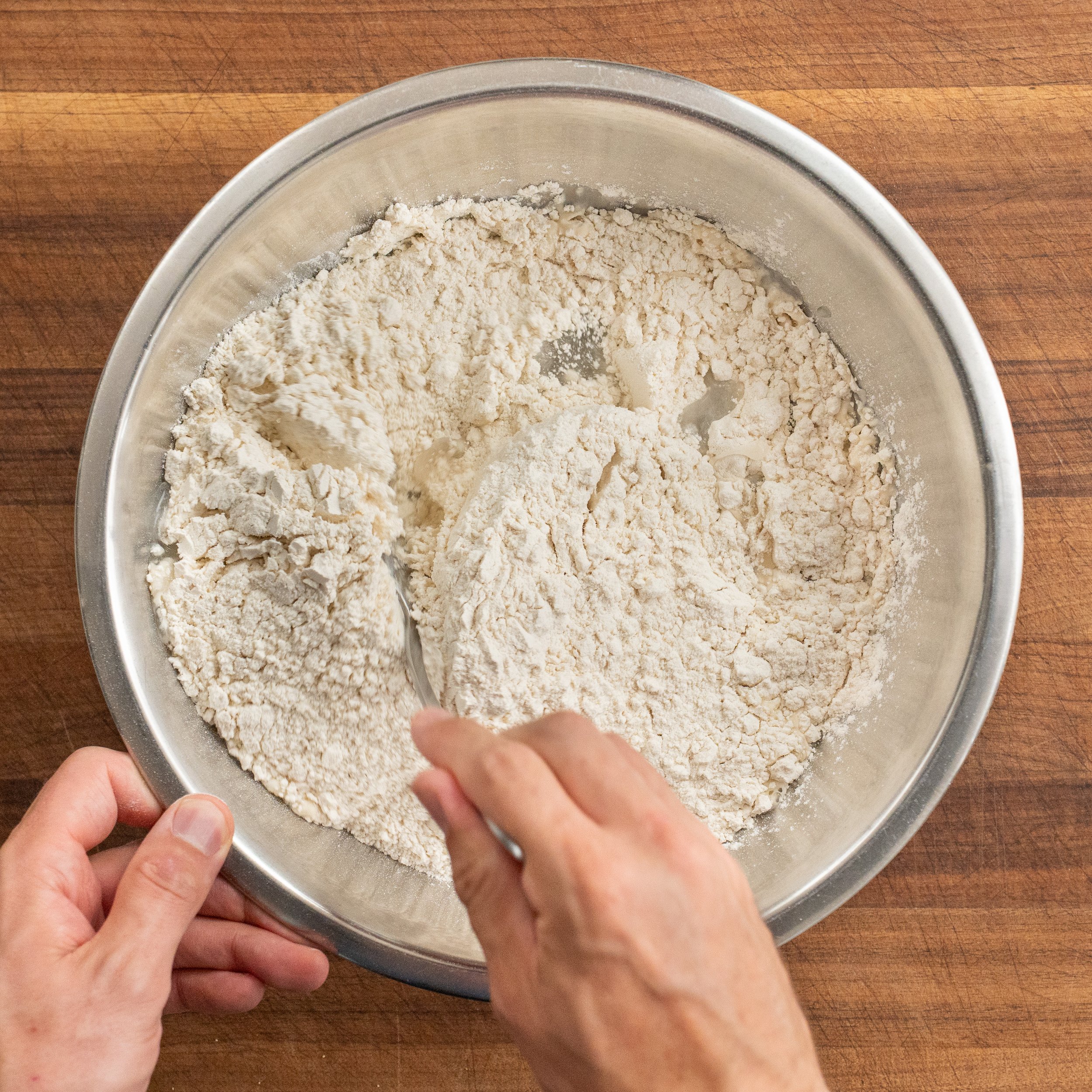 spoon stirring flour into yeast water