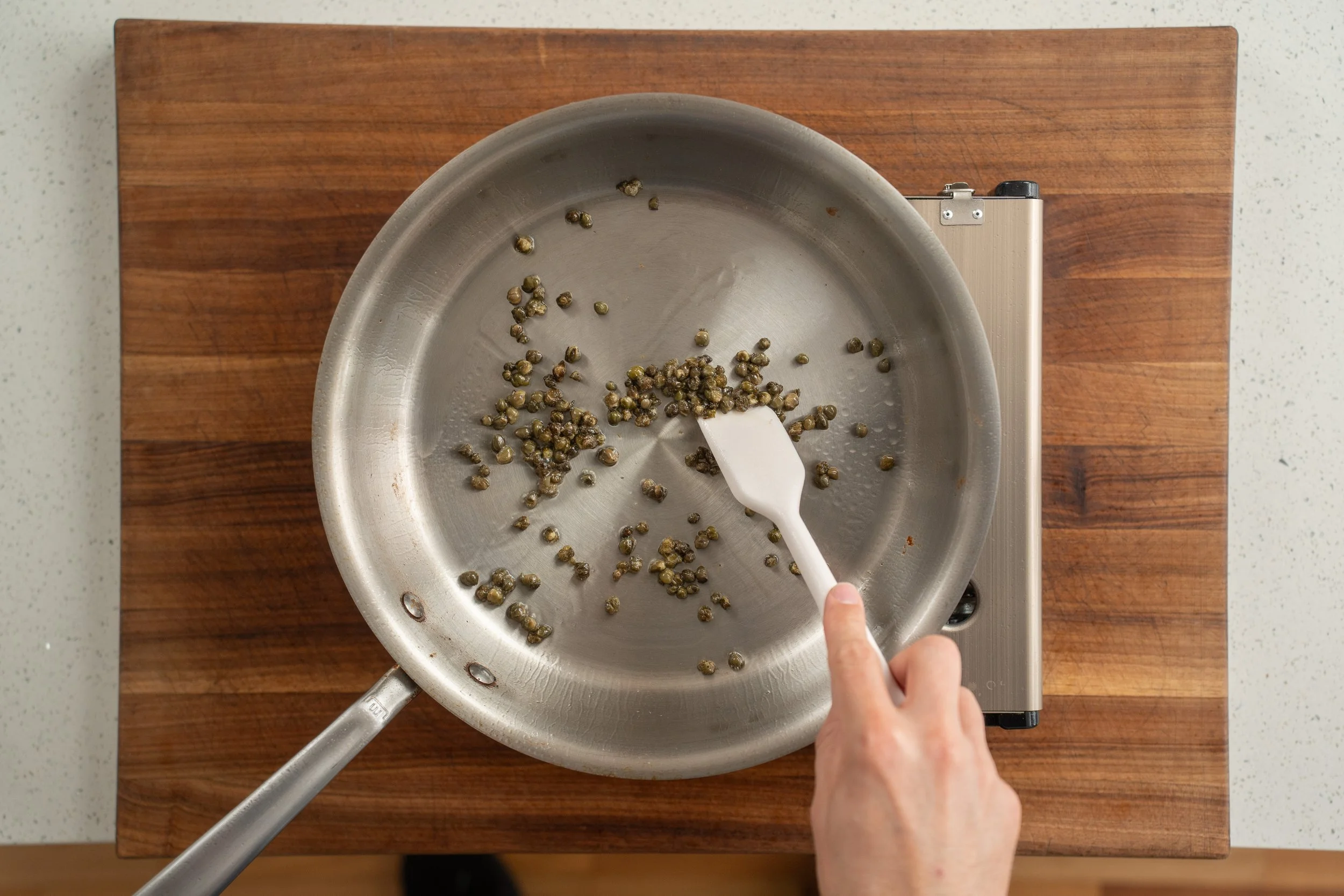 capers frying in a pan