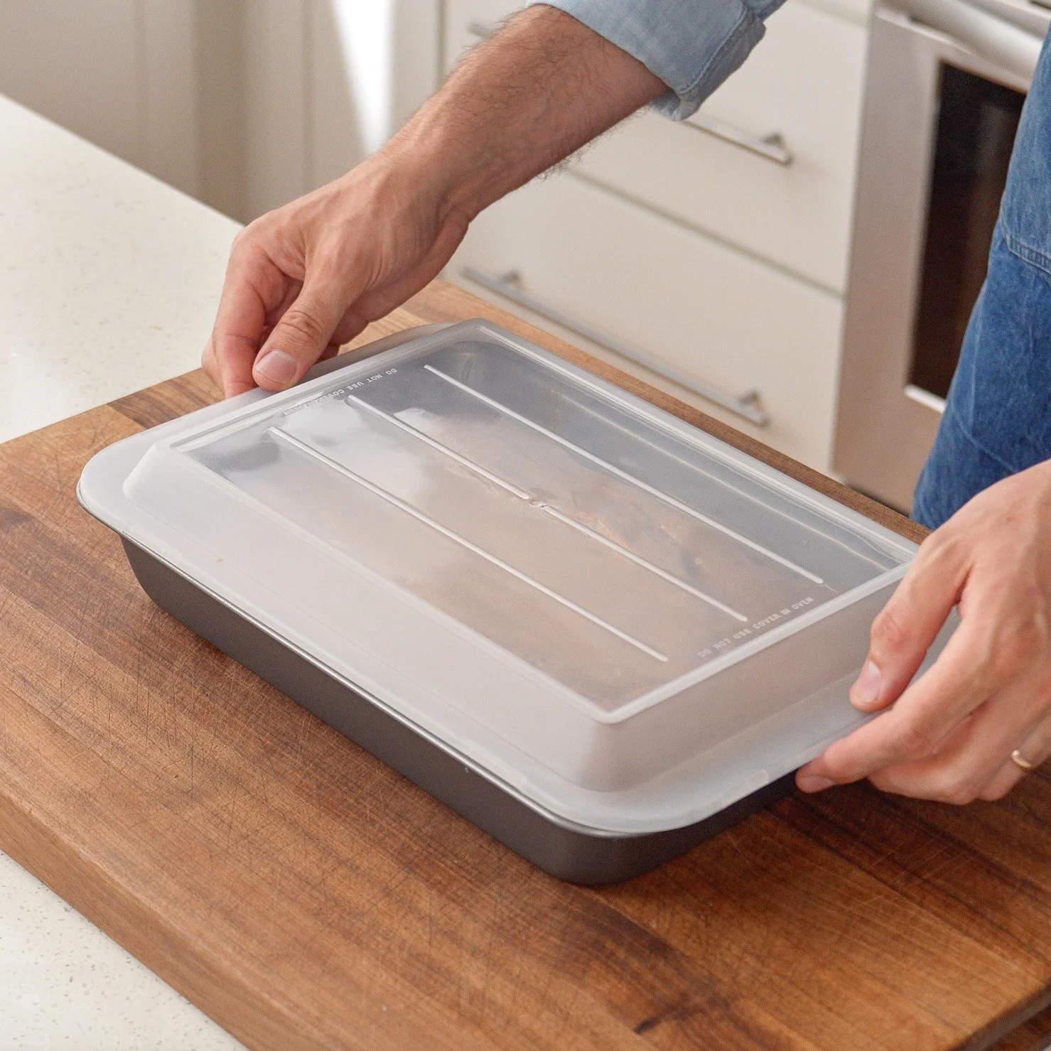placing cover on a 9 by 13 baking dish