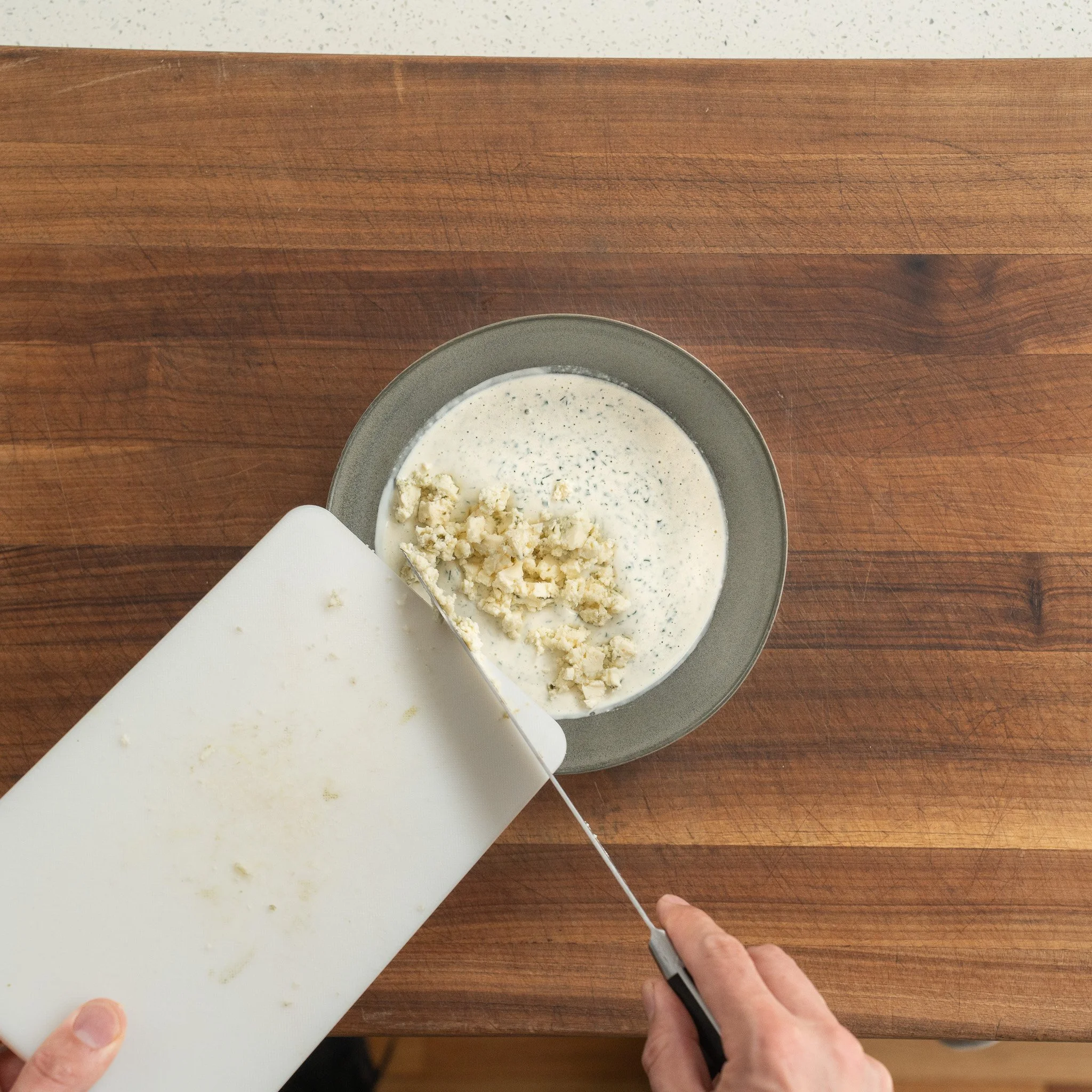 adding chopped blue cheese into dressing