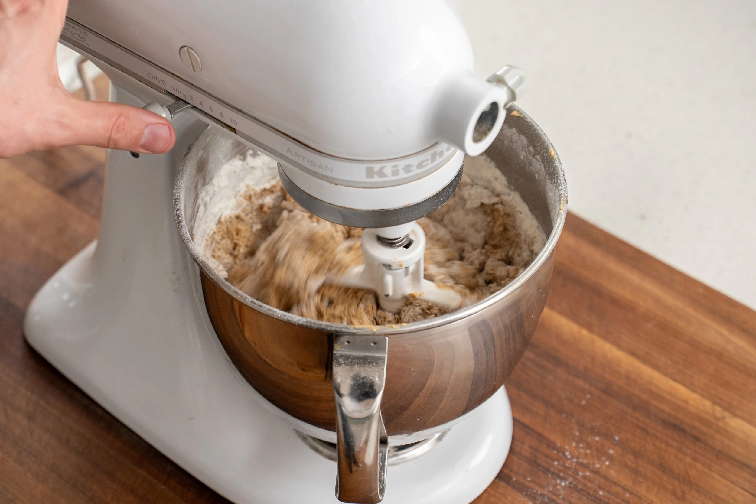 peanut butter cookie ingredients being creamed in a stand mixer