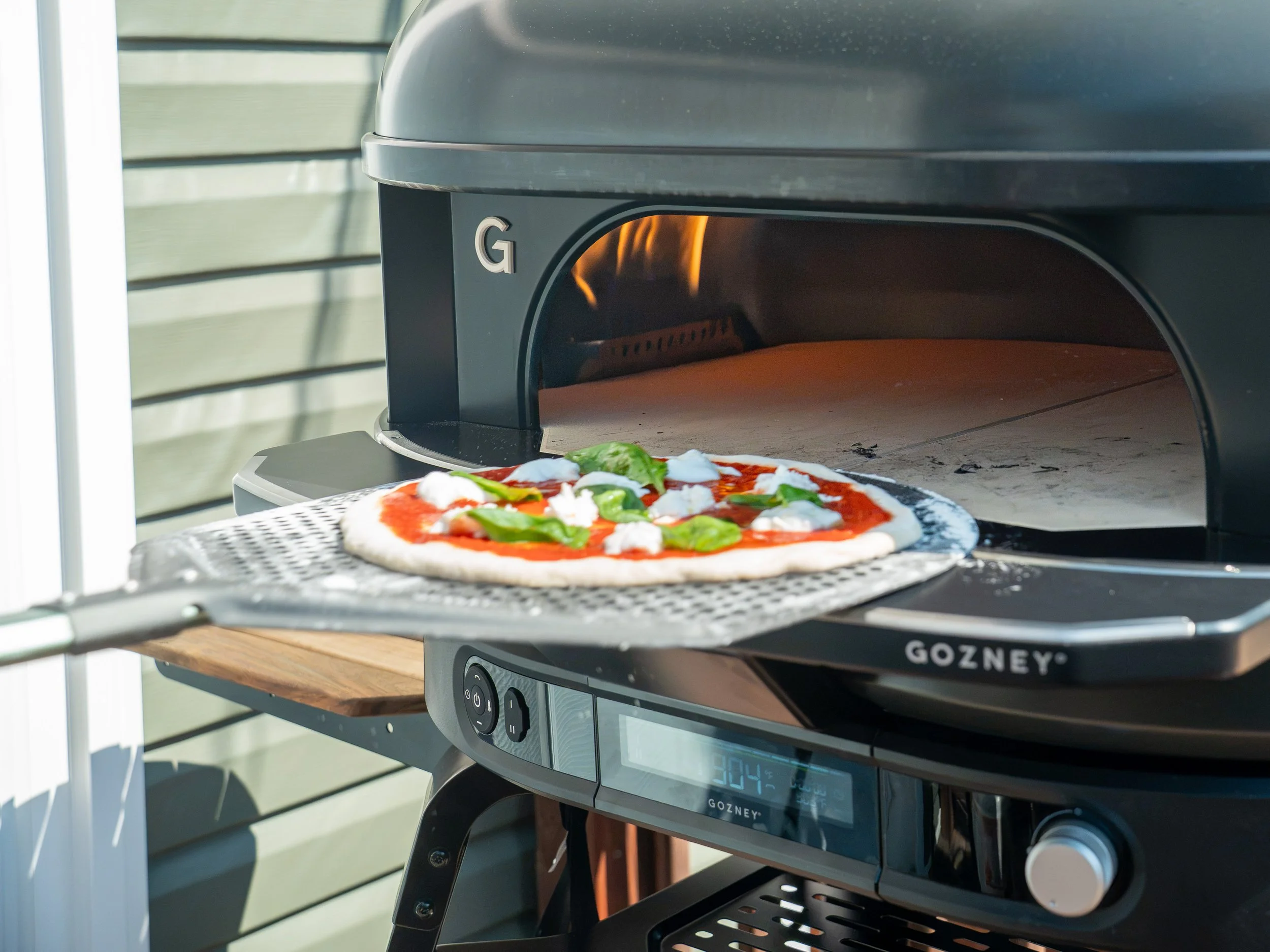 loading Neapolitan pizza into gozney pizza oven