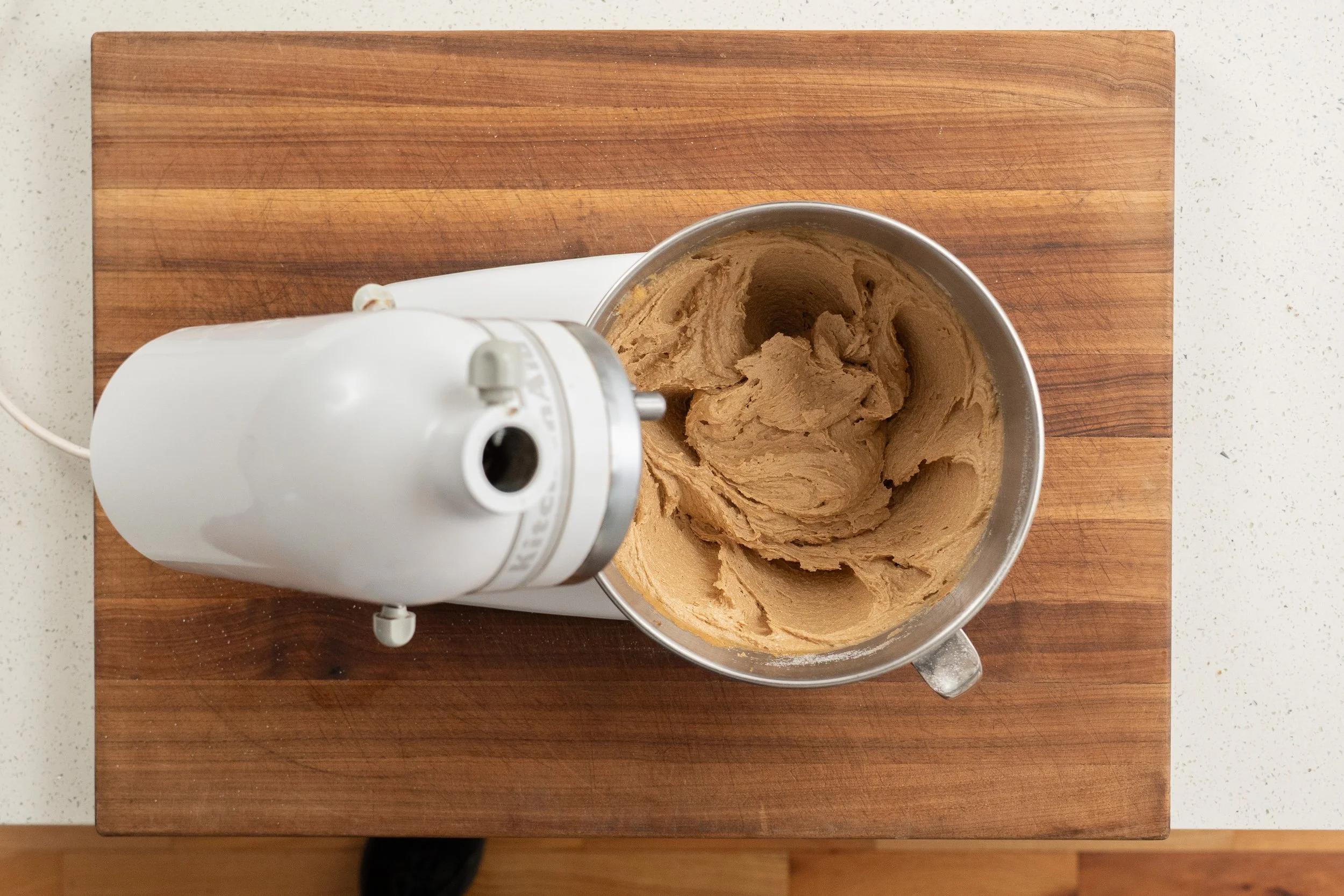 creamed peanut butter cookie ingredients in a stand mixer bowl