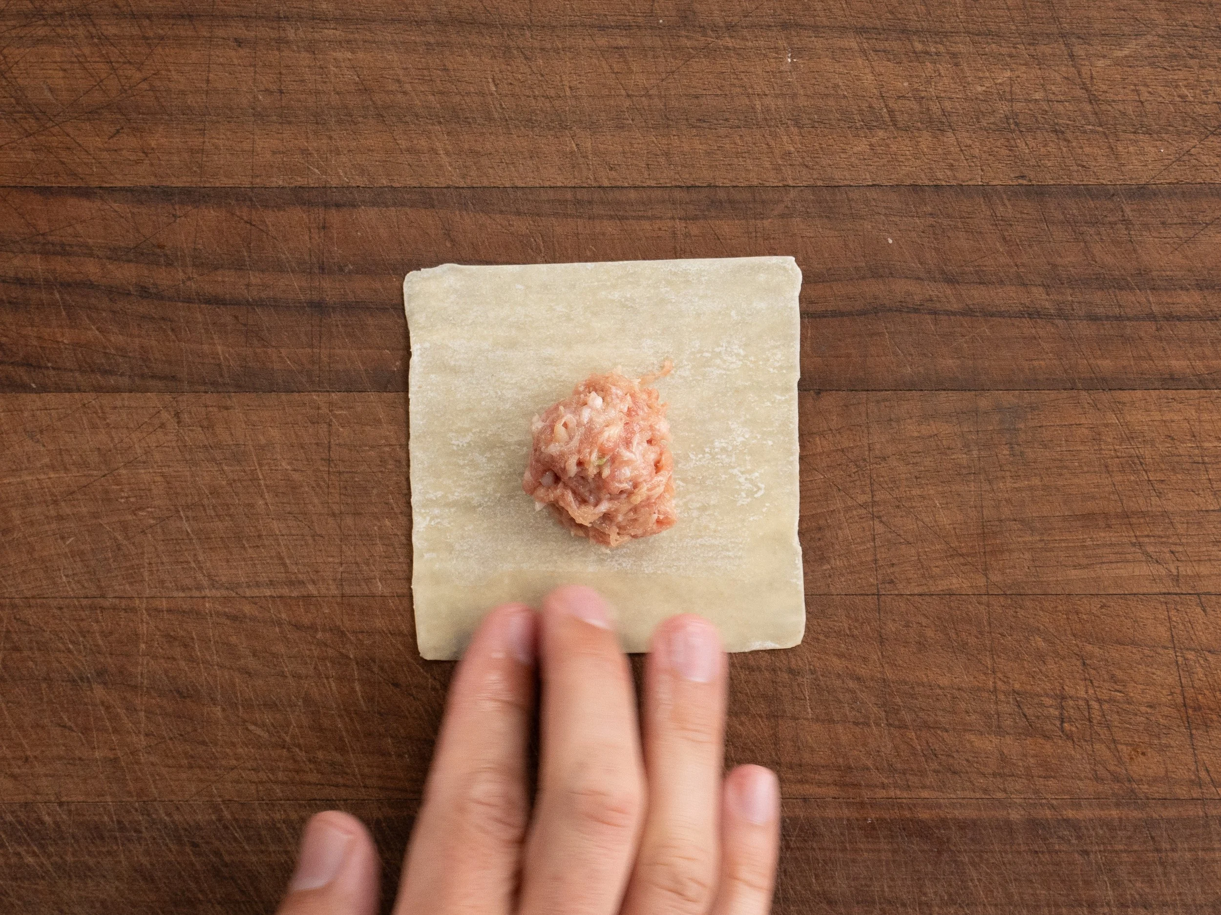 pork filling on a square wonton wrapper