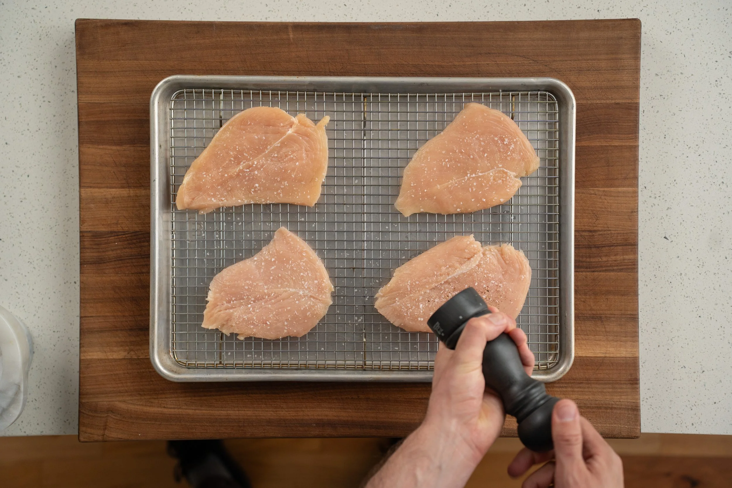 seasoning chicken breast with salt and pepper