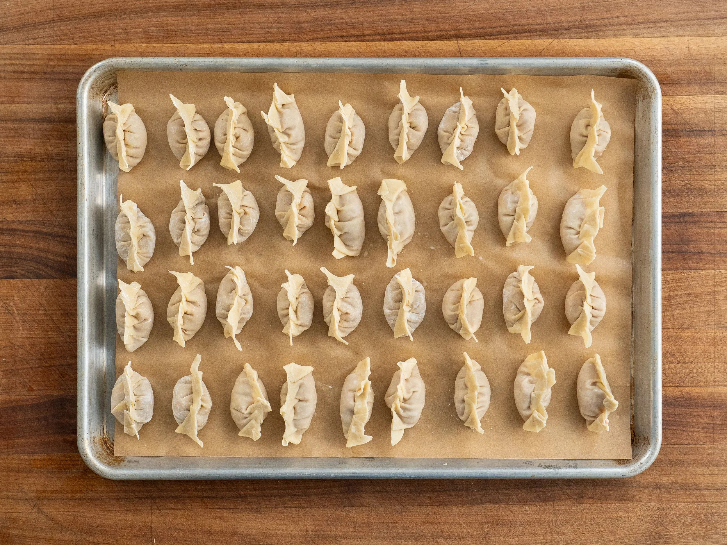 36 wontons on a parchment lined sheet tray