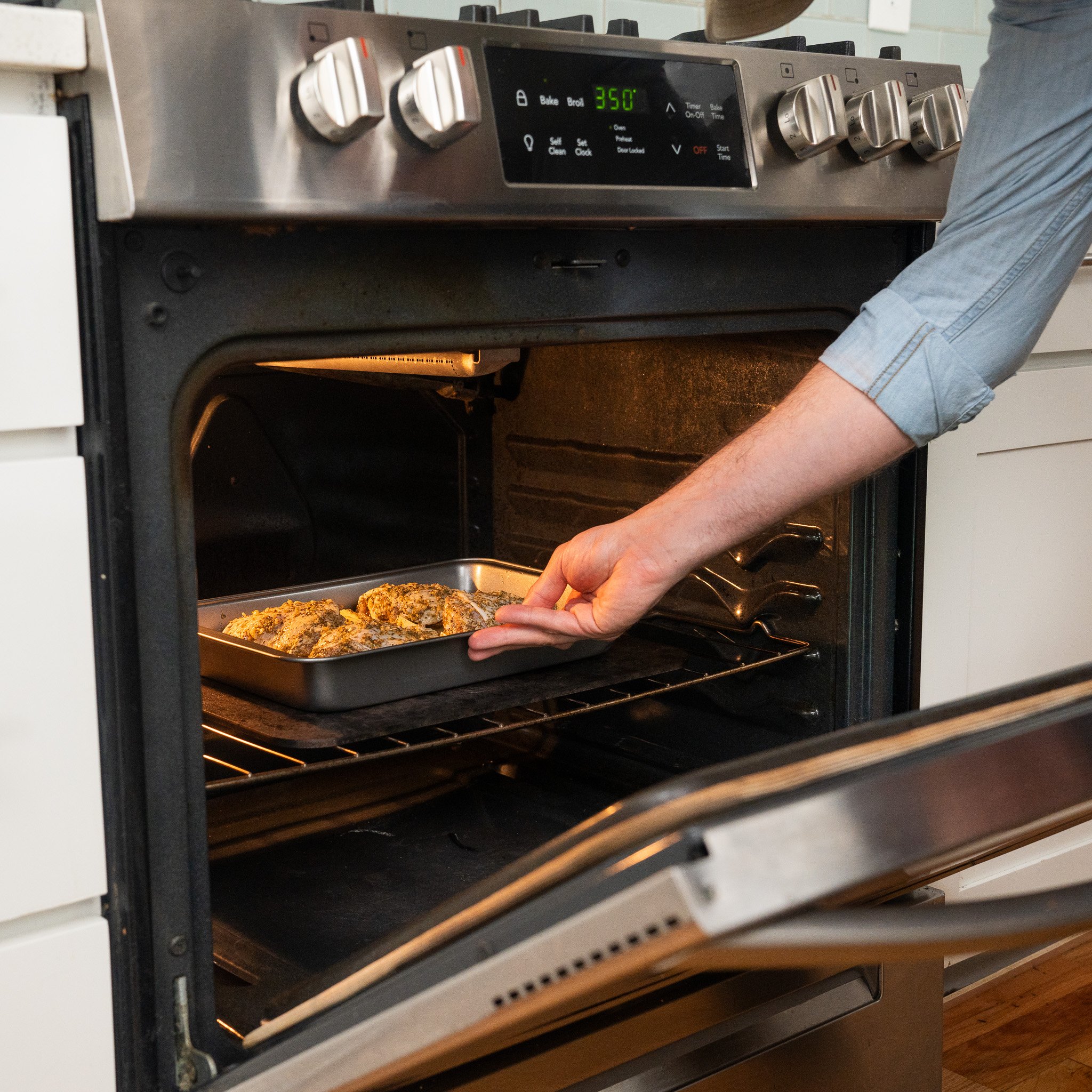 roasting chicken and potatoes in an oven