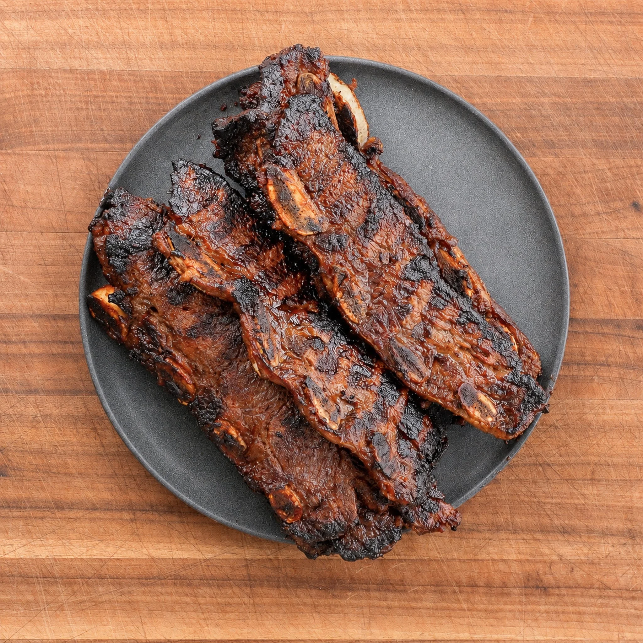 grilled korean short ribs on a black plate