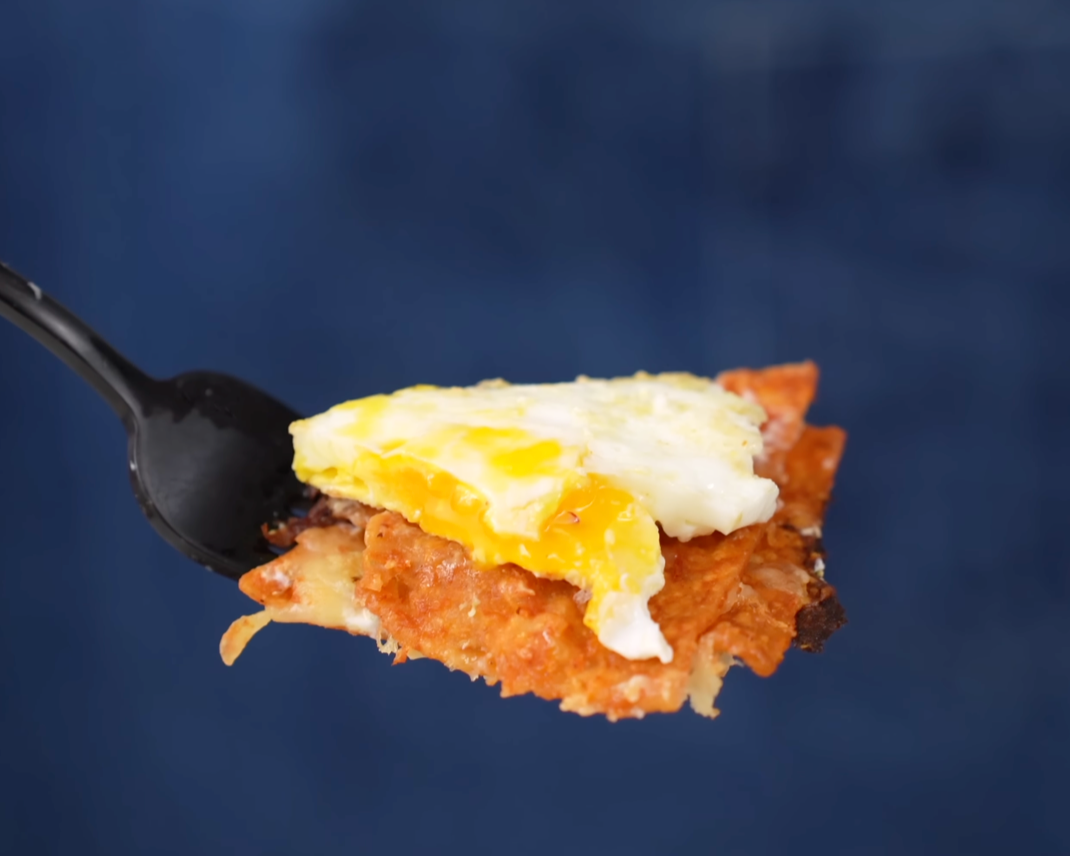 perfect bite of chilaquiles with chip and egg