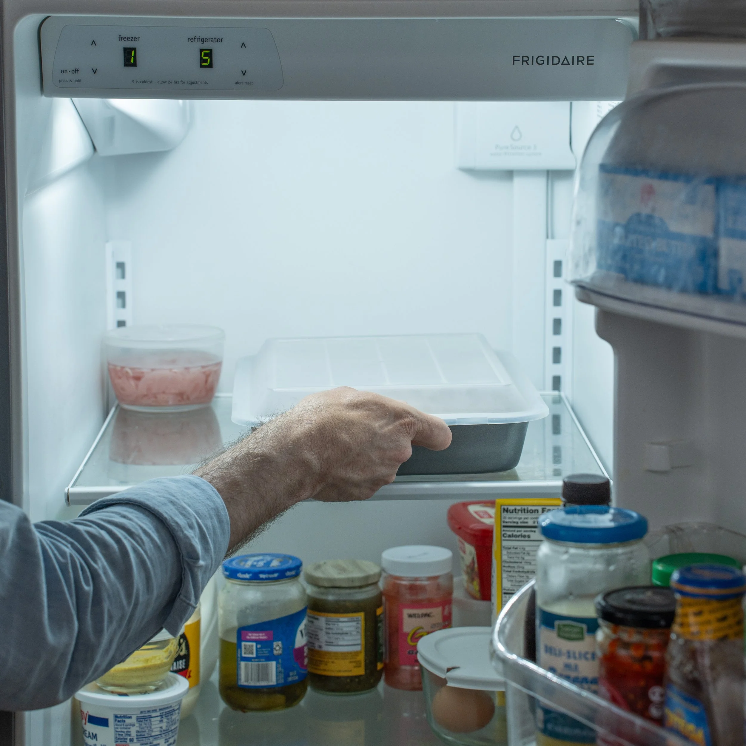 placing covered baking pan in refrigerator