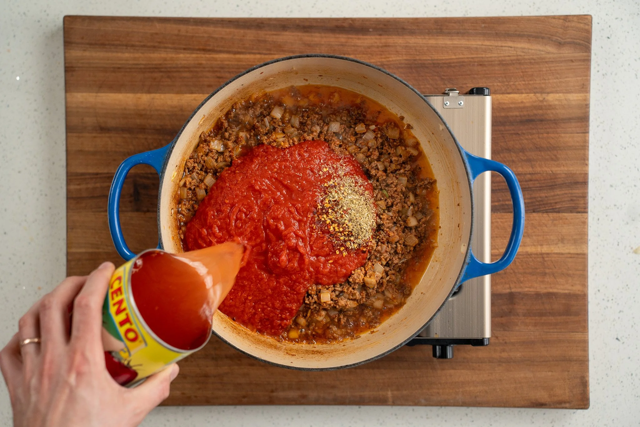 adding crushed tomatoes