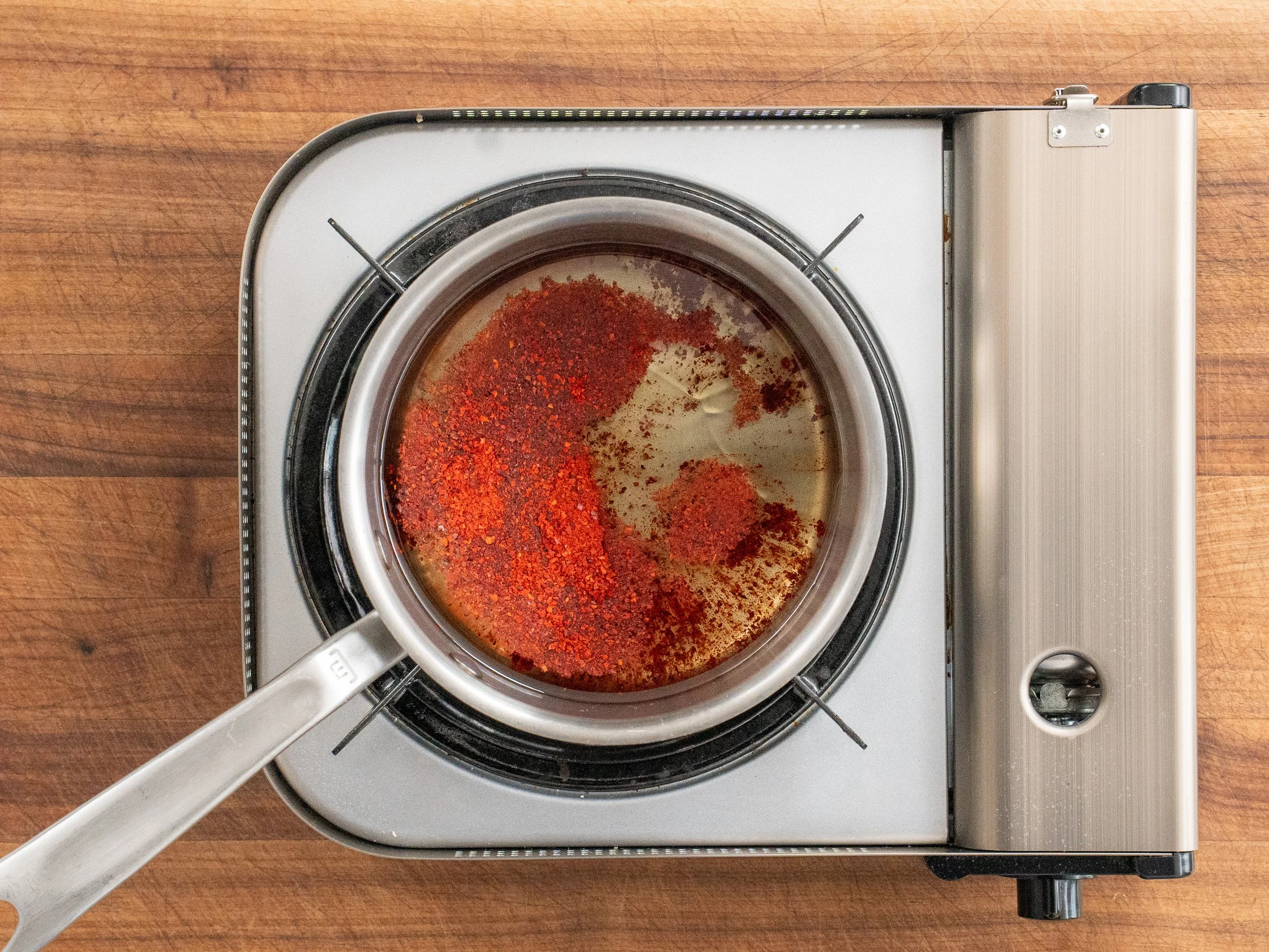 gochugaru and oil in a sauce pan