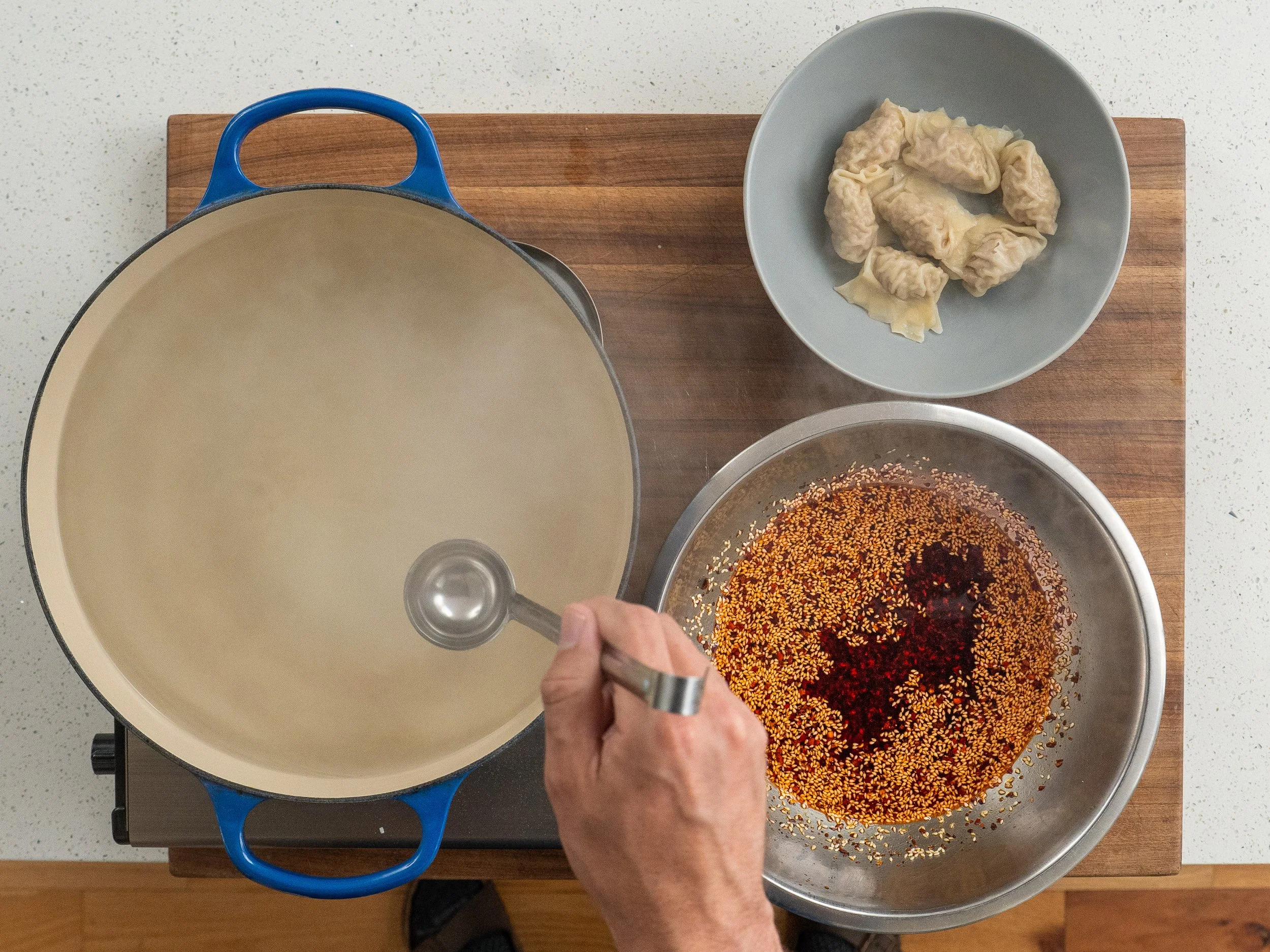 ladle in blue dutch oven of steaming water