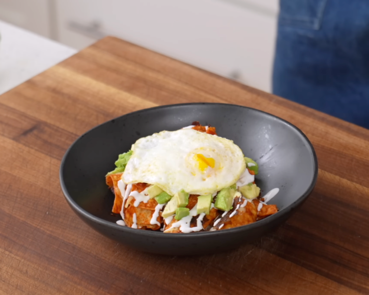 bowl of chilaquiles with avocado and egg
