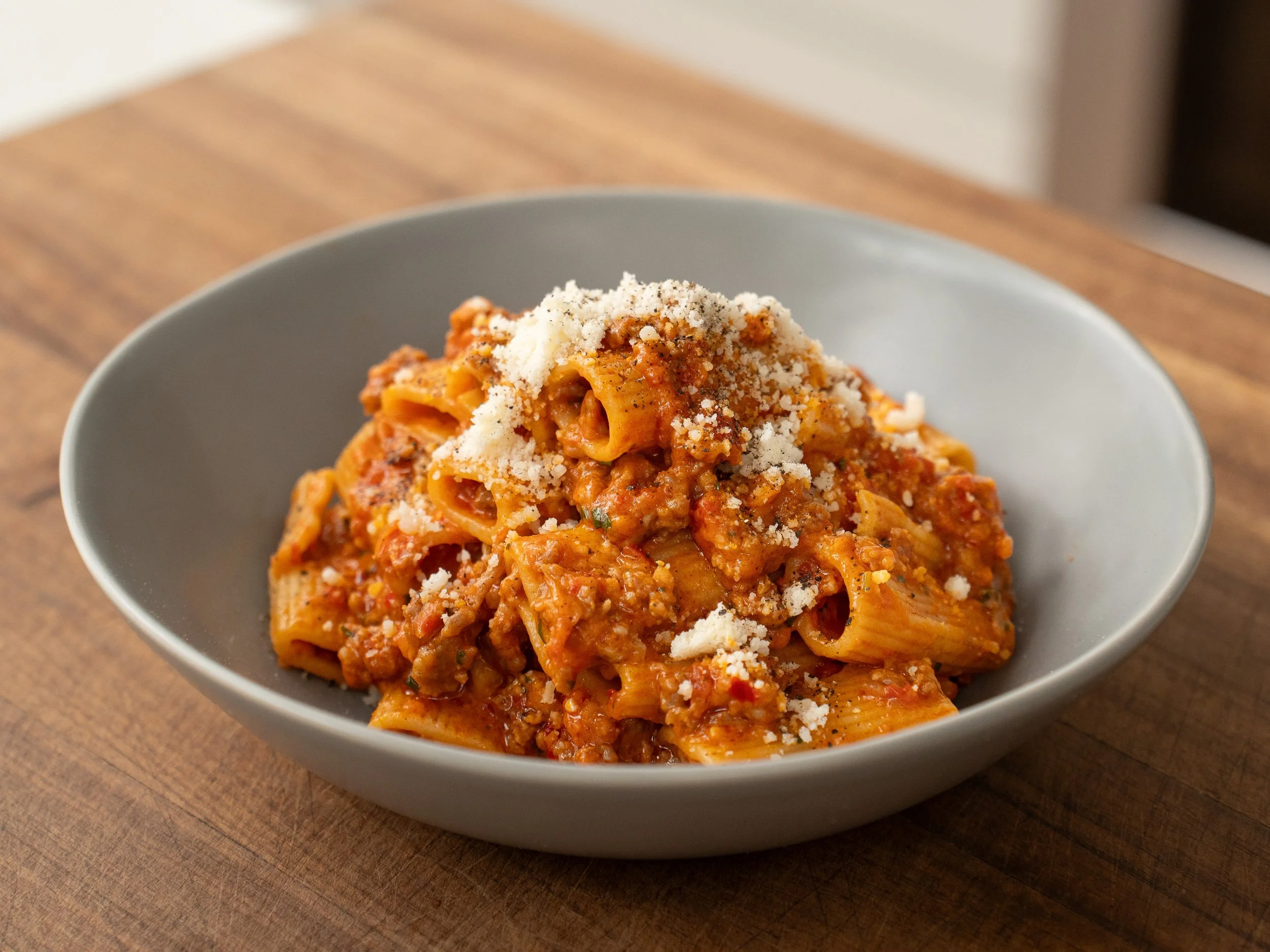 sausage rigatoni pasta in grey bowl