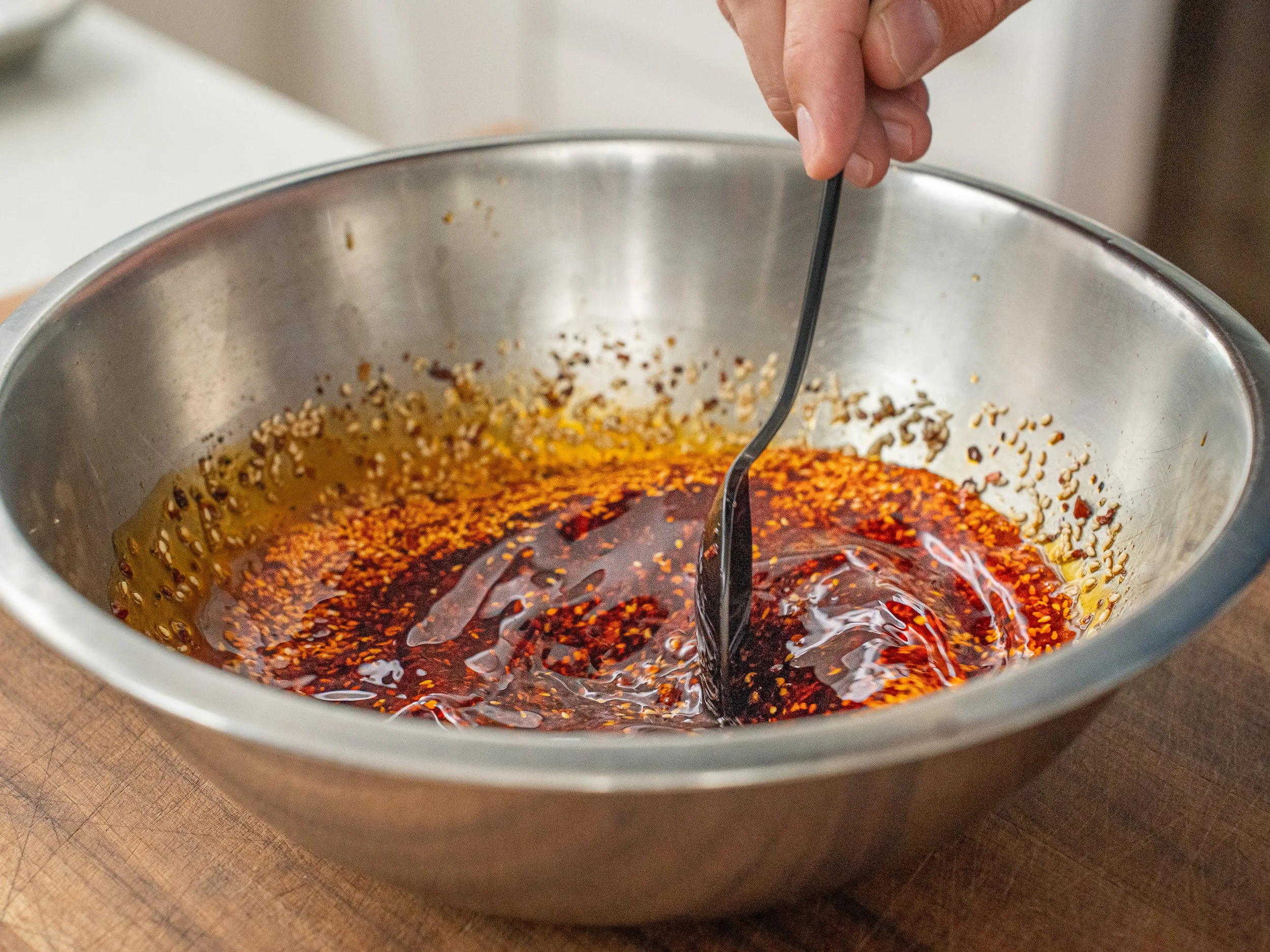 black spoon stirring chili oil