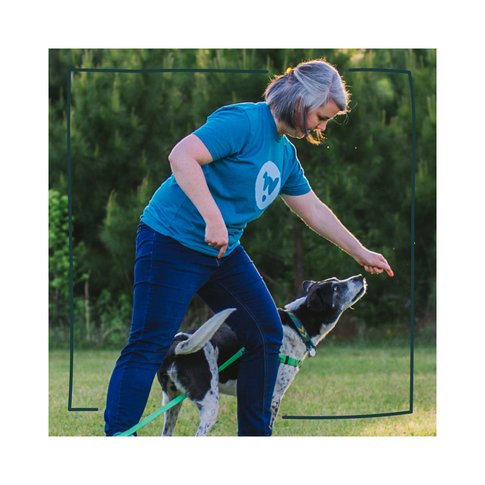 Dog trainer Eryn Rolison clicker trains her black and white mixed breed dog to weave through legs.