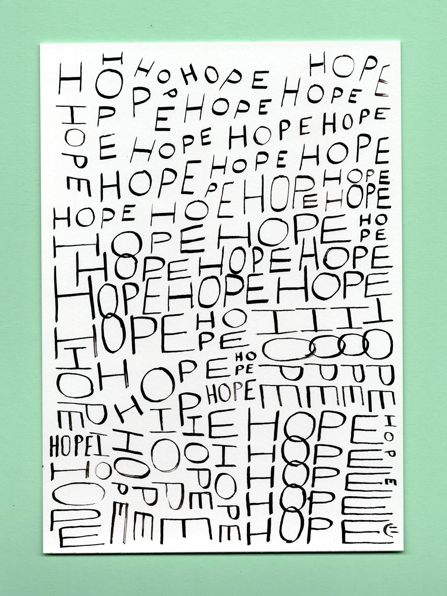 A sheet with various handwritten letters spelling out 'HOPE' and 'PE' repeatedly, with some words enclosed in circles, on a green background.