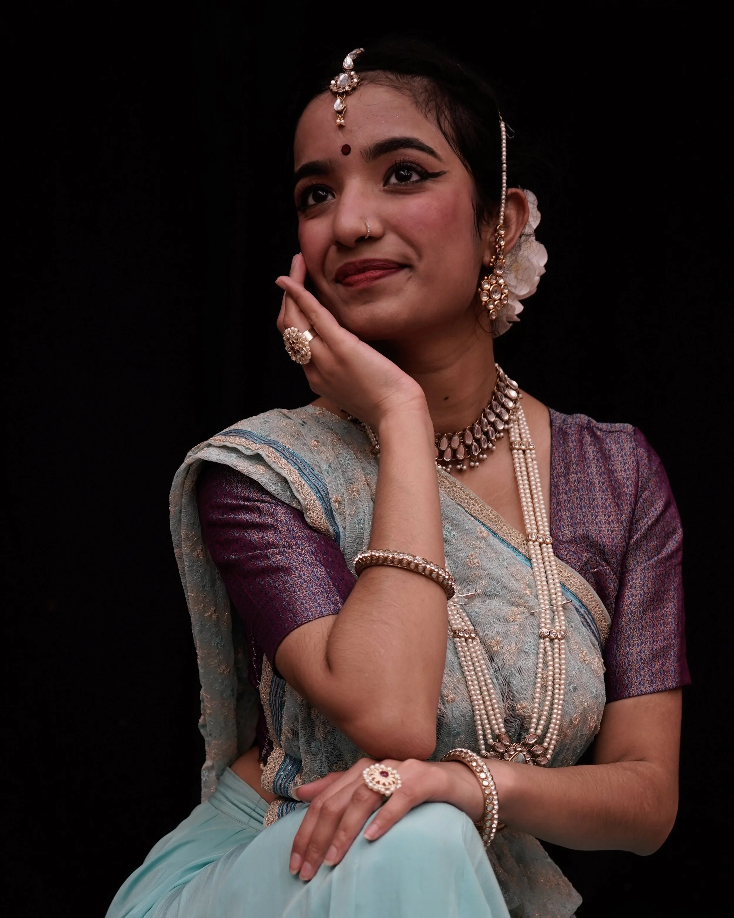 Asian American woman in purple and seafoam sari