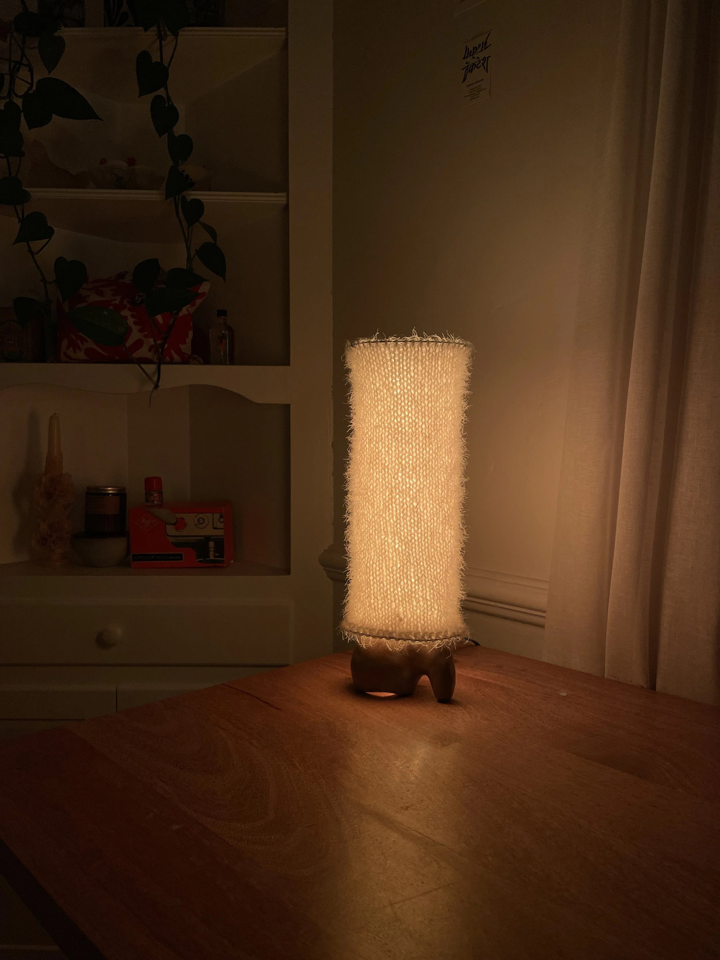 'Neverending Light' recipient of second place from IESLA lighting awards. Stainless steel wire, yarn, wood dowels and clay