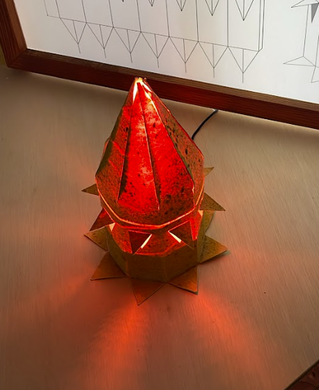 'Best By 10/10/26', orange peel bioplastic lamp, 2026. Made to decompose in six months, recepient of fourth place IESLA 26 lighting awards