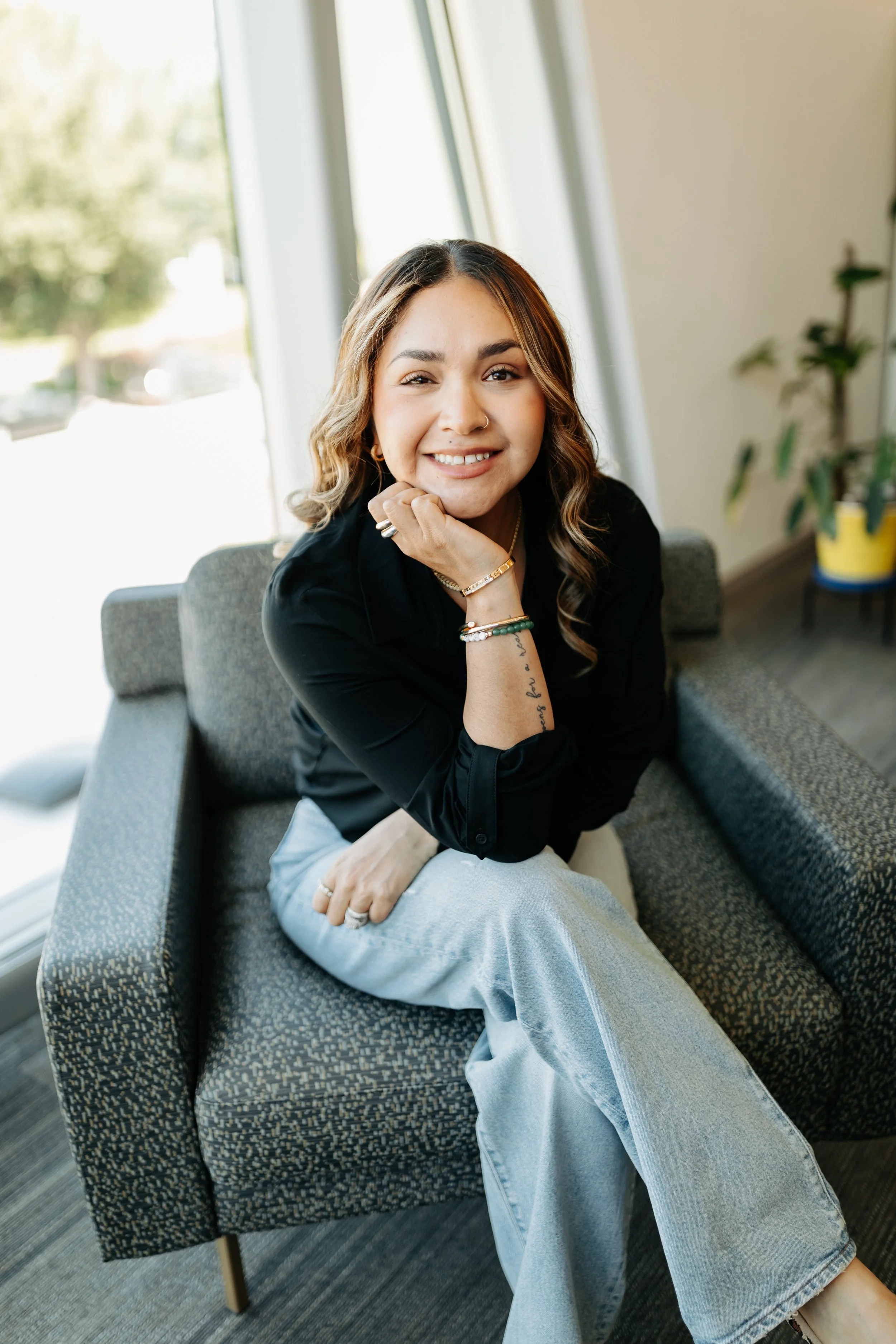 Merit Weight Loss & Wellness' Sara - MA - Sitting Smiling With her Legs Crossed