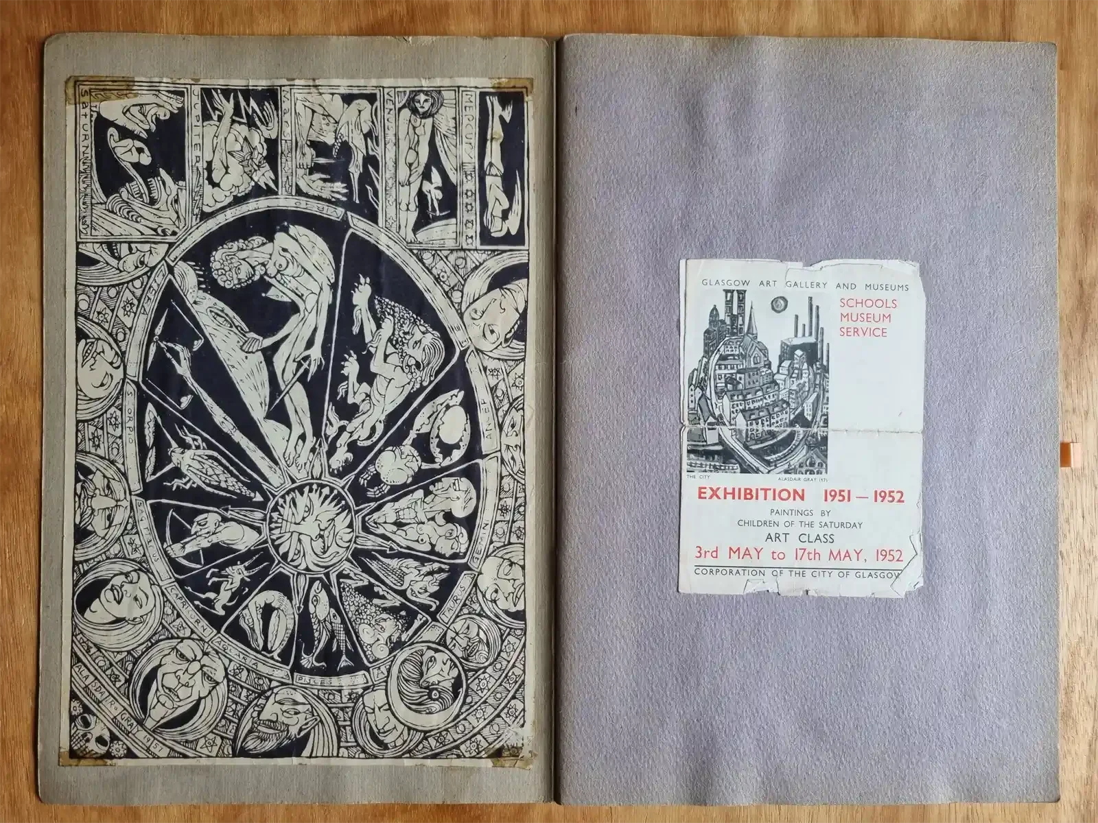 An open scrapbook. Left, a black and white zodiac print signed Alasdair Gray 1951. Right, a worn leaflet for a 1952 exhibition of paintings by children of the Saturday art class.