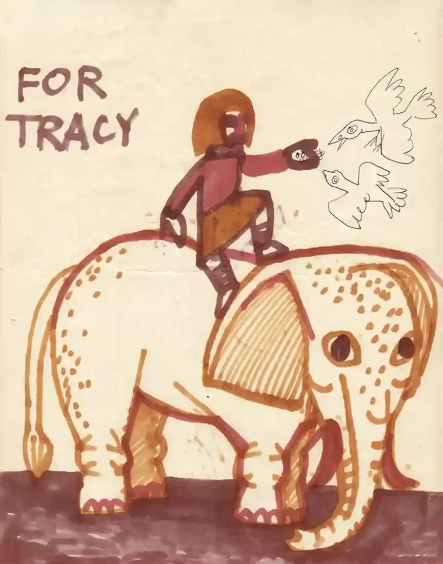 Felt-tip drawing lettered "For Tracy": a long-haired rider in a red tunic sits astride a large spotted elephant, one arm raised towards two birds outlined in ink.