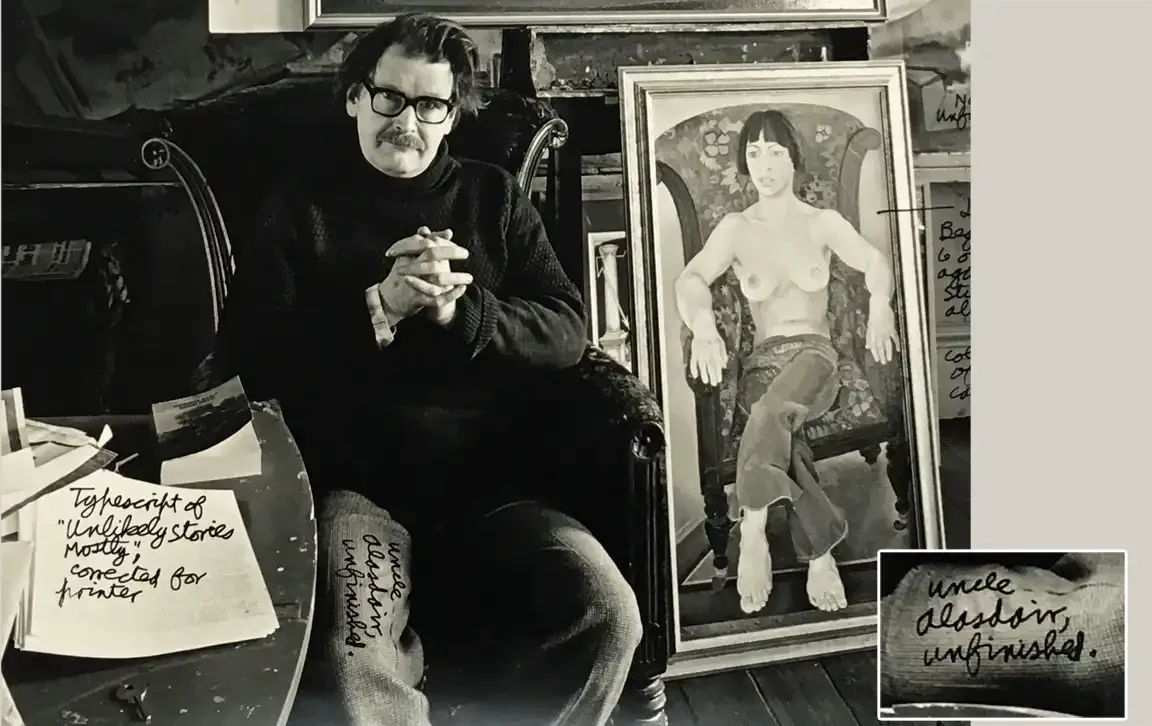 Black and white photo of Alasdair Gray in a dark jumper and heavy glasses, hands clasped, seated beside a framed painting of a bare-chested woman in an armchair. Handwritten notes label the print.