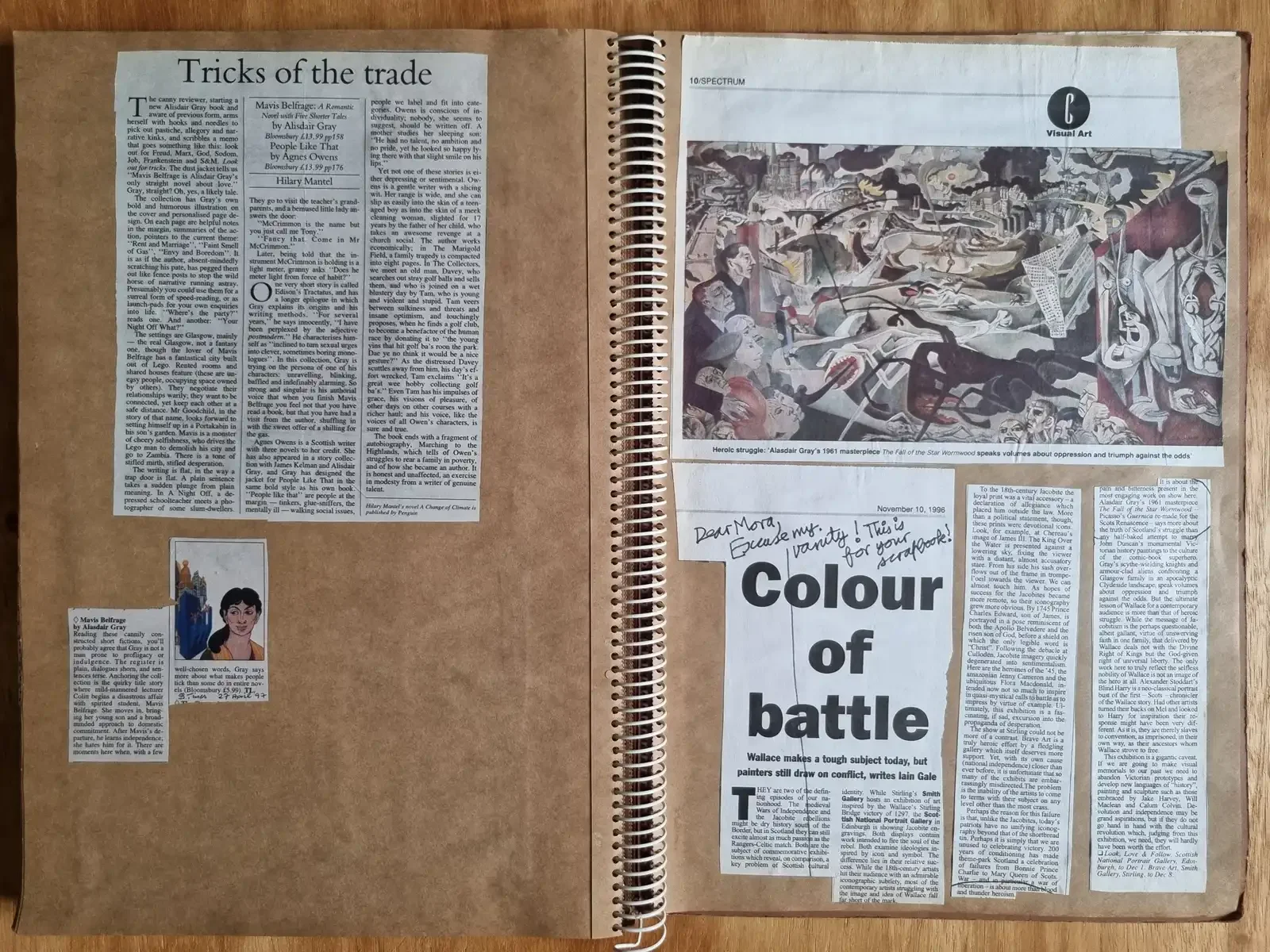 Two scrapbook pages of press cuttings. One reproduces a crowded, apocalyptic painting in colour. A handwritten note reads 'Dear Mora, Excuse my vanity! This is for your scrapbook!'