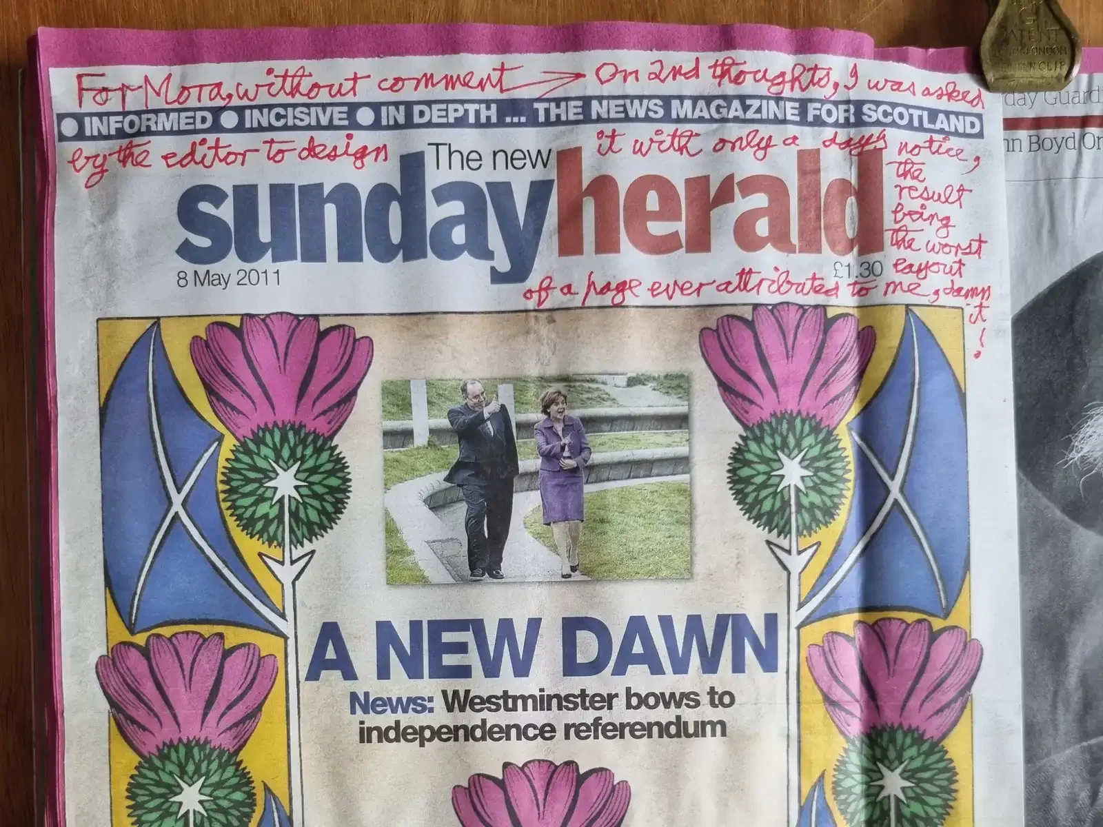 The top of a Sunday Herald front page dated 8 May 2011, its masthead framed by Alasdair's pink thistles and blue saltires. Red handwriting runs across and around the printed headlines.