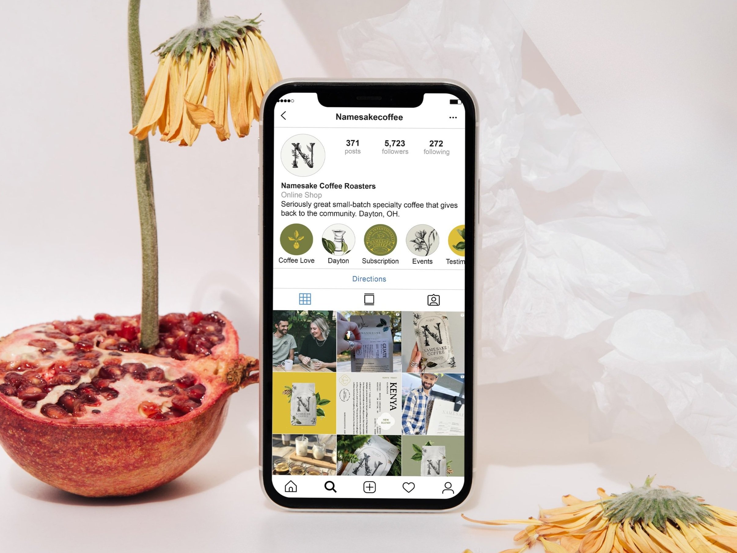 iphone mockup with pomegranate and flowers showing social media design.
