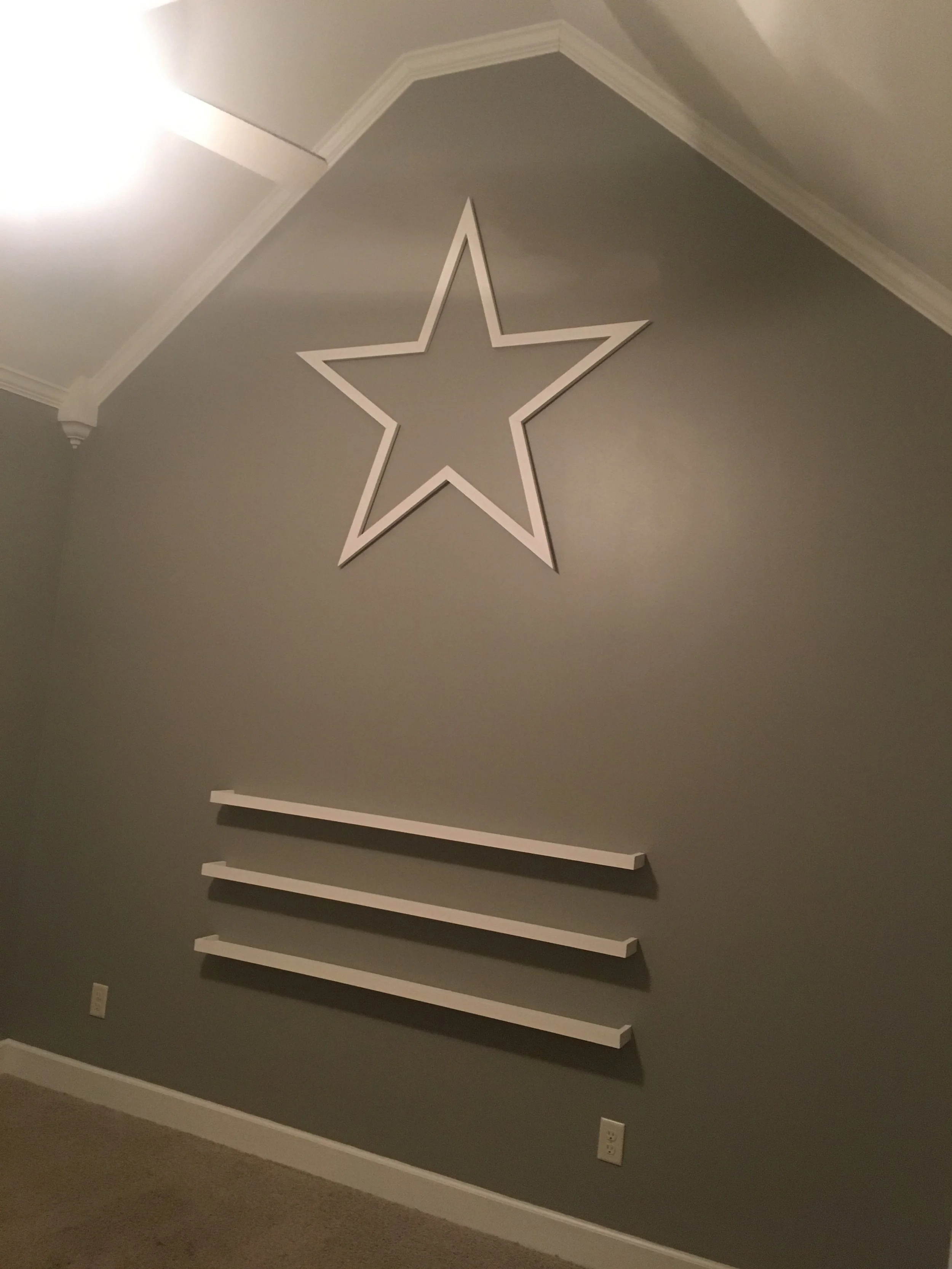 Handmade wall star and floating shelves. 