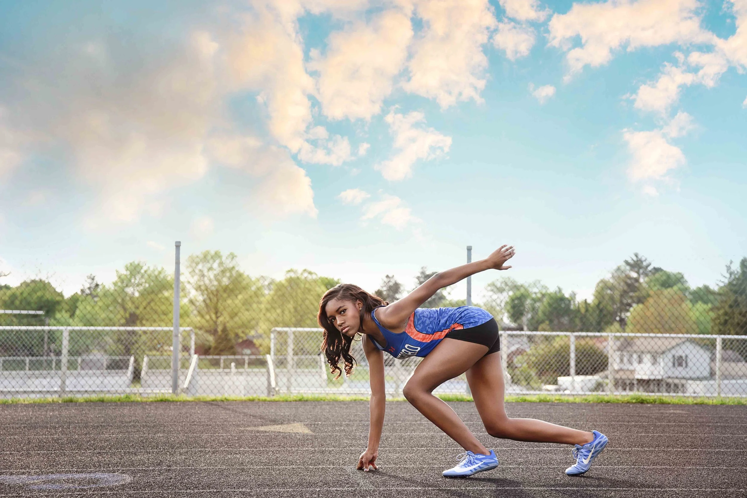 High school track athlete senior portrait on the starting line in Shenandoah county, Virginia